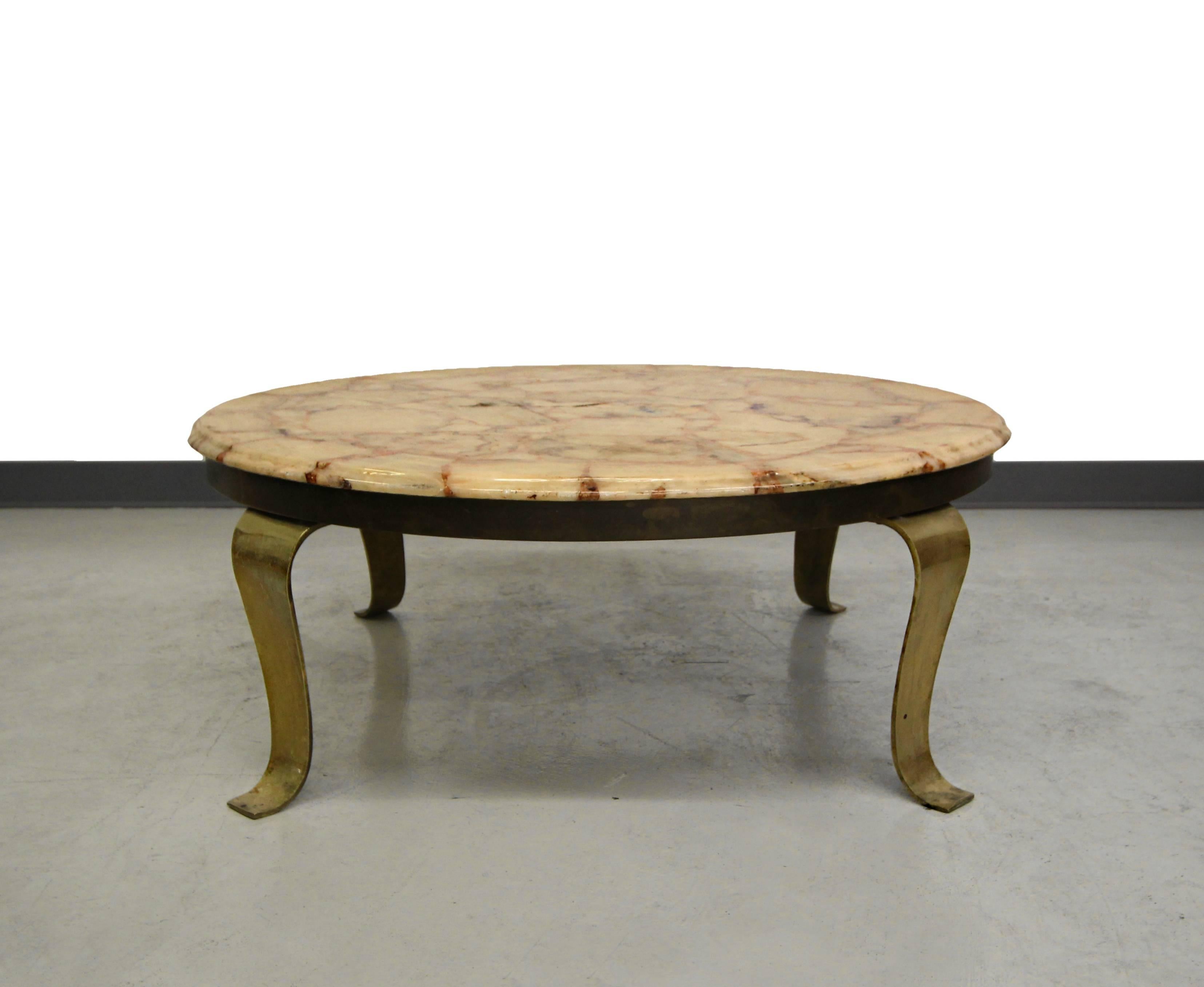 Gorgeous onyx coffee table designed by Roberto and Mito Block for Muller Onyx. Table has a gorgeous marbled onyx top mounted on beautiful scrolling solid brass legs and solid brass edge banding. Brass has been left as is showing beautiful patina but