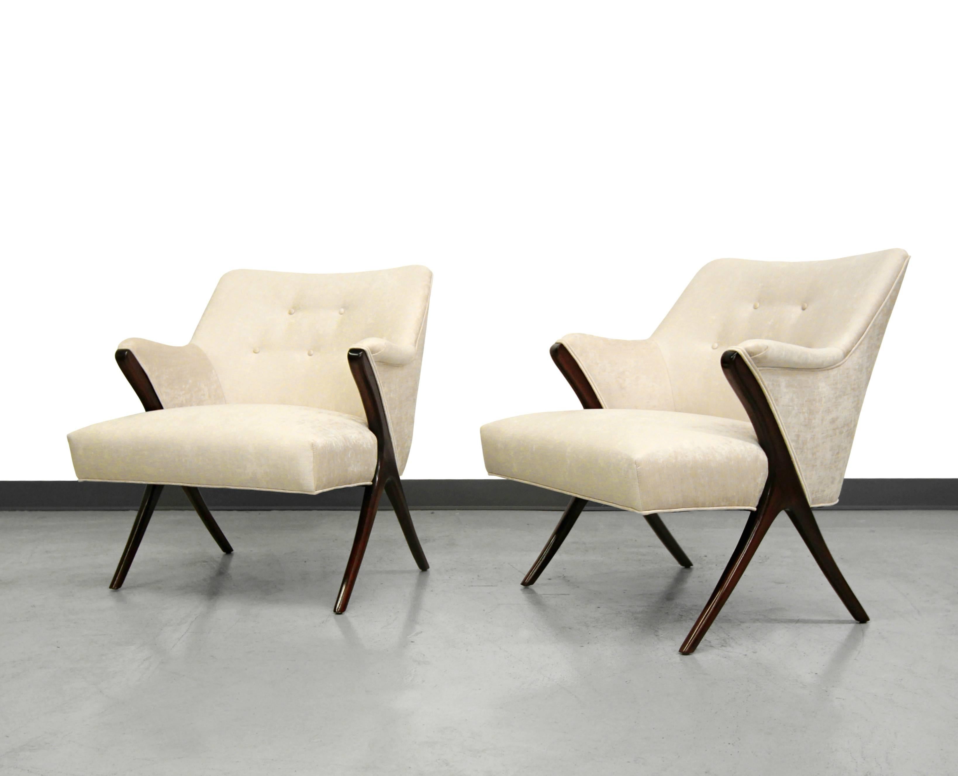 This exquisite pair of Mid-Century scissor lounge chairs in the style of Karpen of California are true design masterpieces. Beautiful lines coupled with sculptural frames make these beauties the perfect fit in most any decor. The cream colored