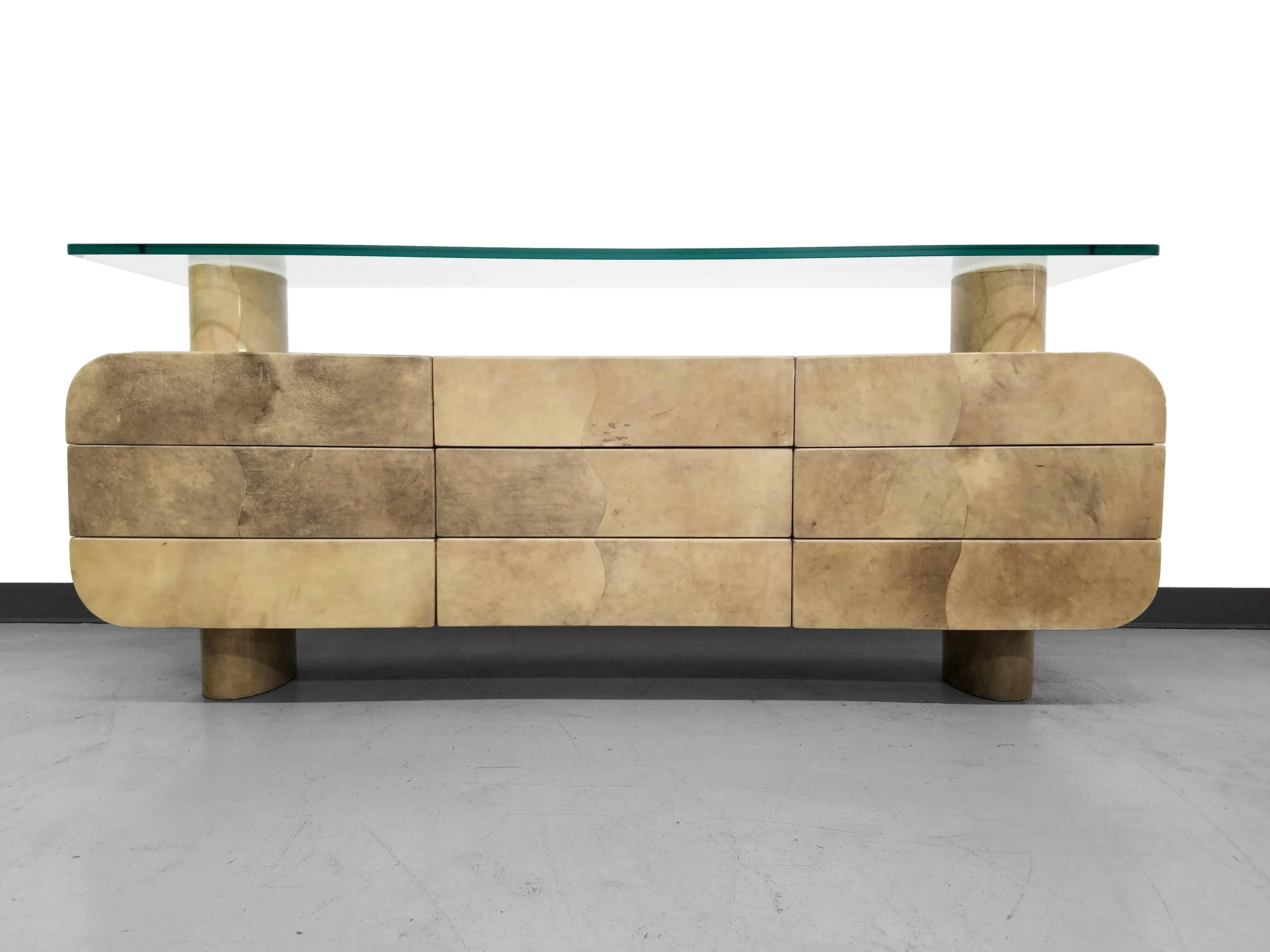 This Italian Aldo Tura piece is fantastic. Unlike any piece of its kind. Finished in the notorious goatskin and lacquer this piece is a designer masterpiece. It really seems to float. Bottom unit has nine drawers with an advanced push to open