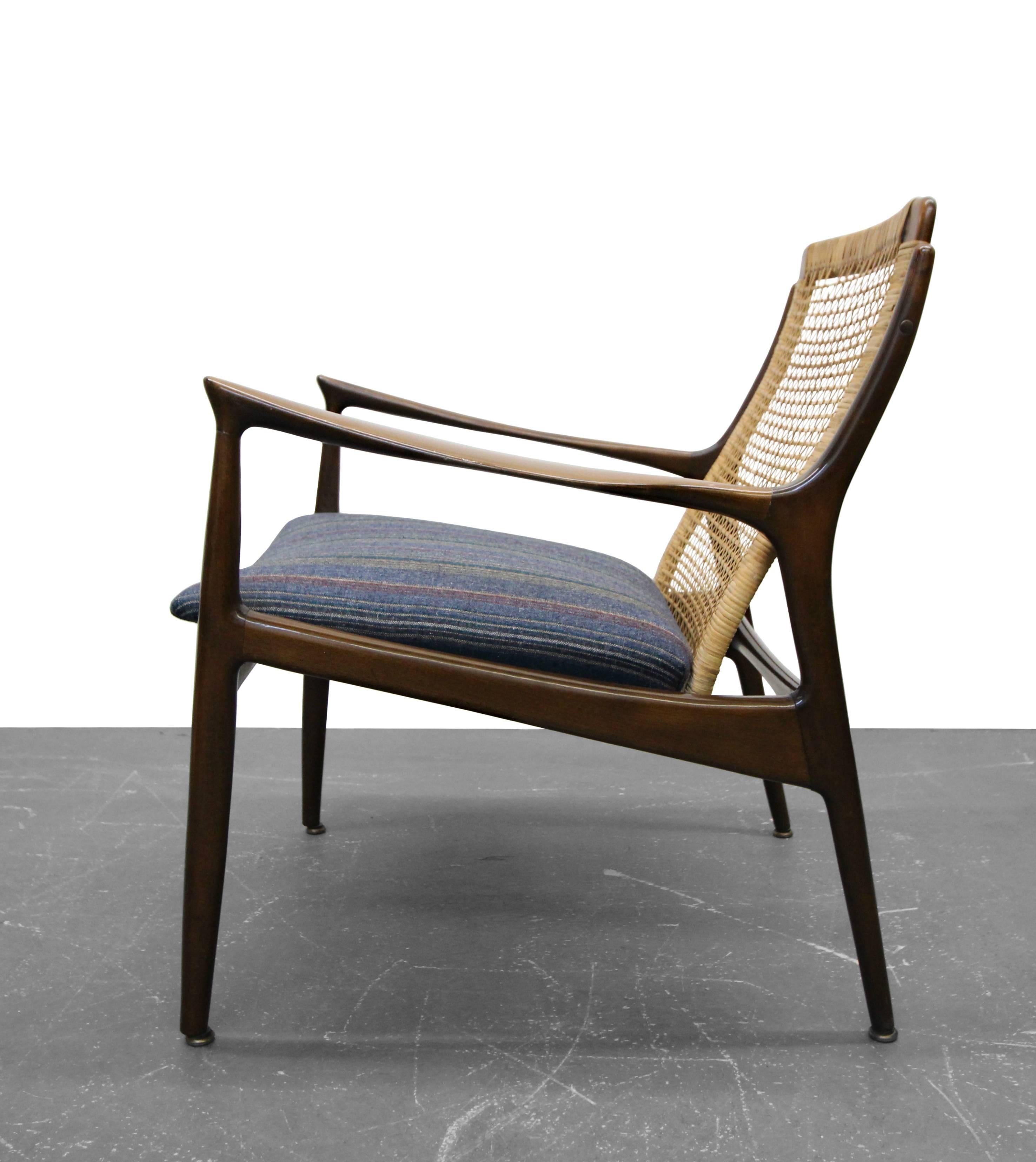 Classic Danish lounge chair by IB Kofod Larsen. A simply beautiful chair with great lines and a stunning profile. Chair has a newly upholstered seat. Walnut frame is all original and in good, solid condition. Chair shows minimal signs of age