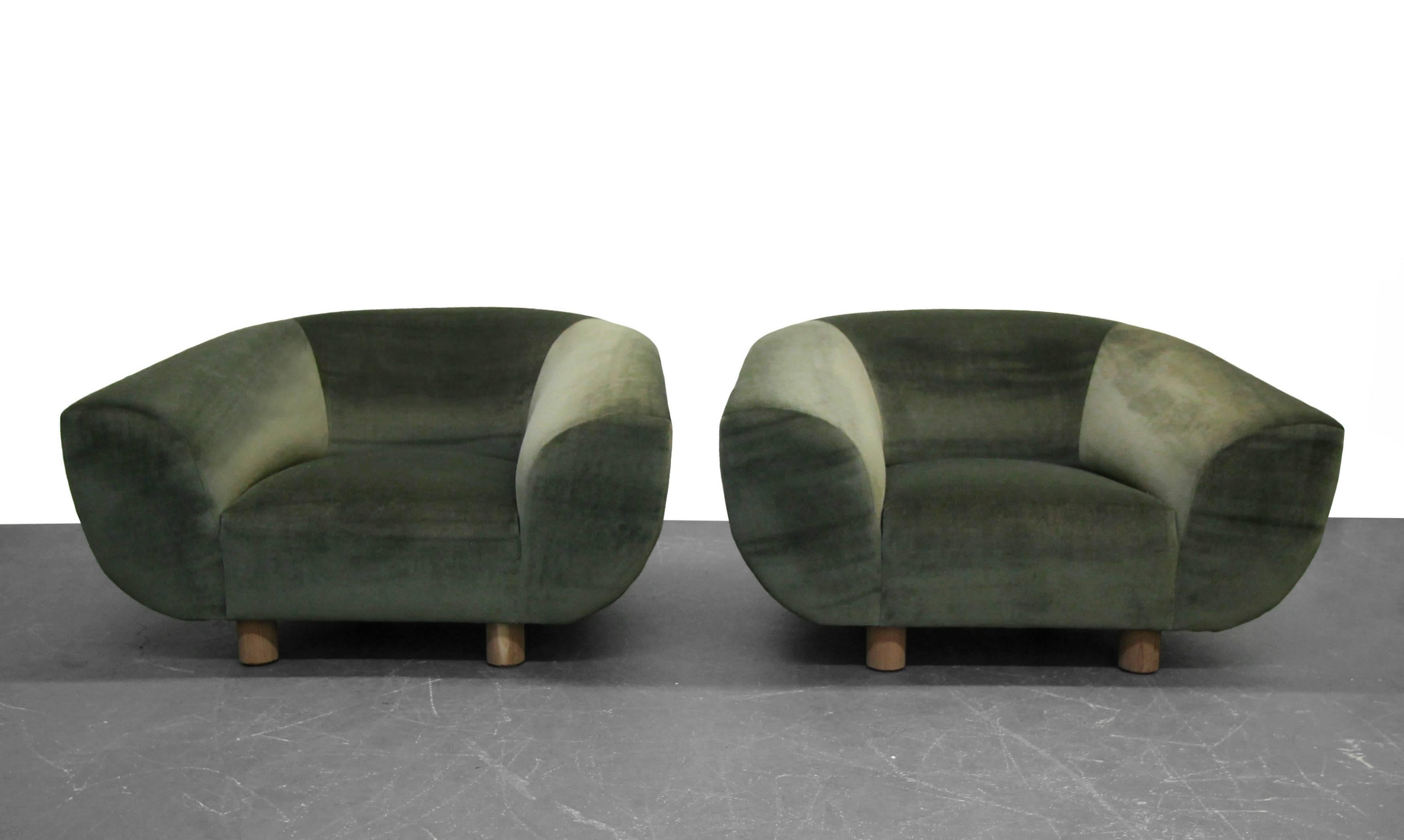 Great, fully restored pair of midcentury polar bear style barrel chairs after Jean Royere.. Snag the amazing look at a fraction of the cost.

Completely restored with all new foam and dark green micro velvet. Chairs are perfect and ready for their