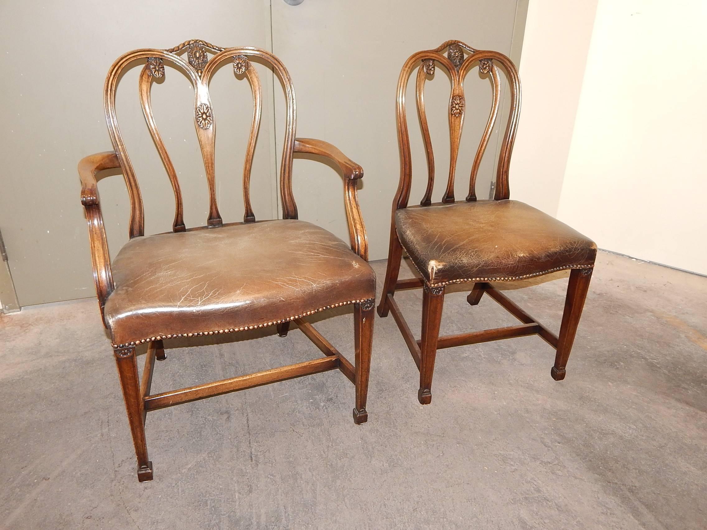 A handsome set of twelve Adams style carved mahogany dining chairs.
Two-arm, ten side.