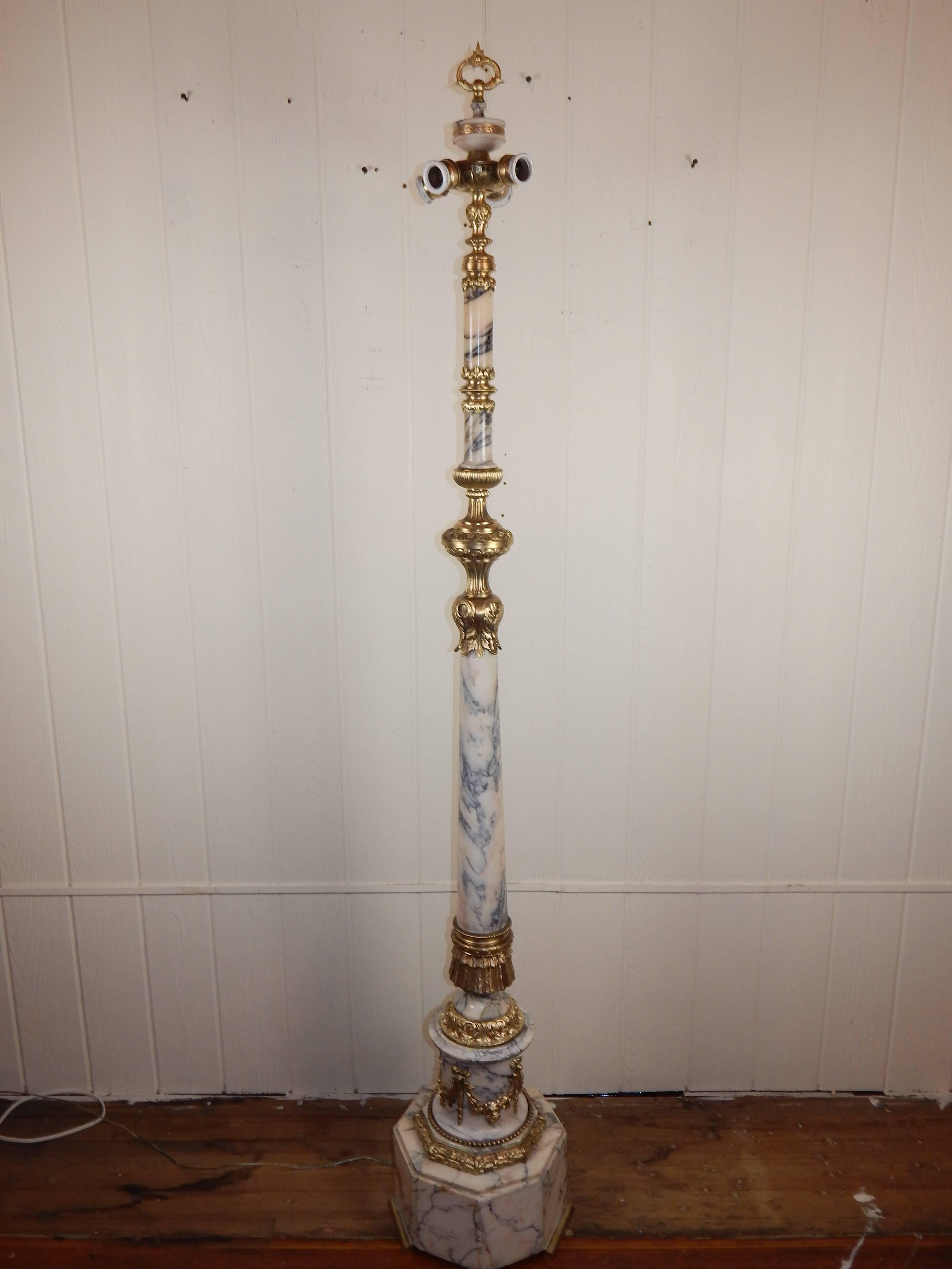 A beautiful Louis XVI style bronze mounted marble floor lamp.

