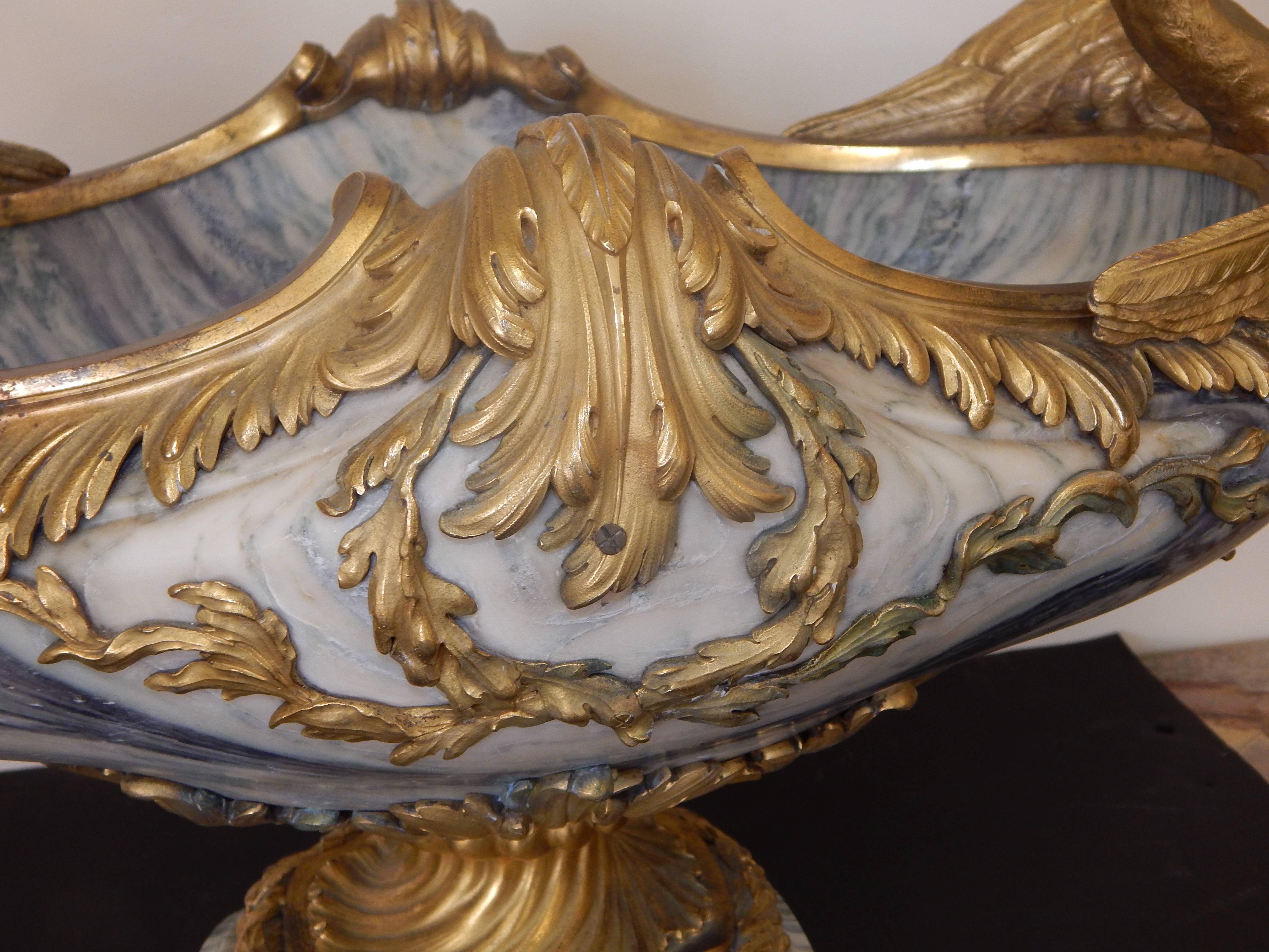 A large and exceptional quality bronze-mounted centerpiece, or coupe, the bronze-mounted on exotic light purple marble, the bronze scrolling, and featuring large swans on both ends.
