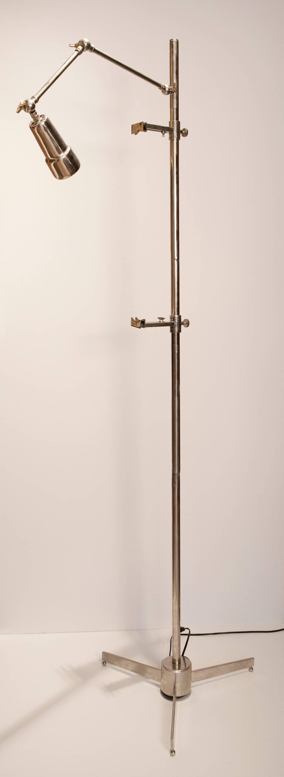 This floor easel lamp captures the spirit of Mid-Century Modern. This example is cast entirely in chrome, has adjustable top and bottom easel claw-hands to display most sizes of artwork.