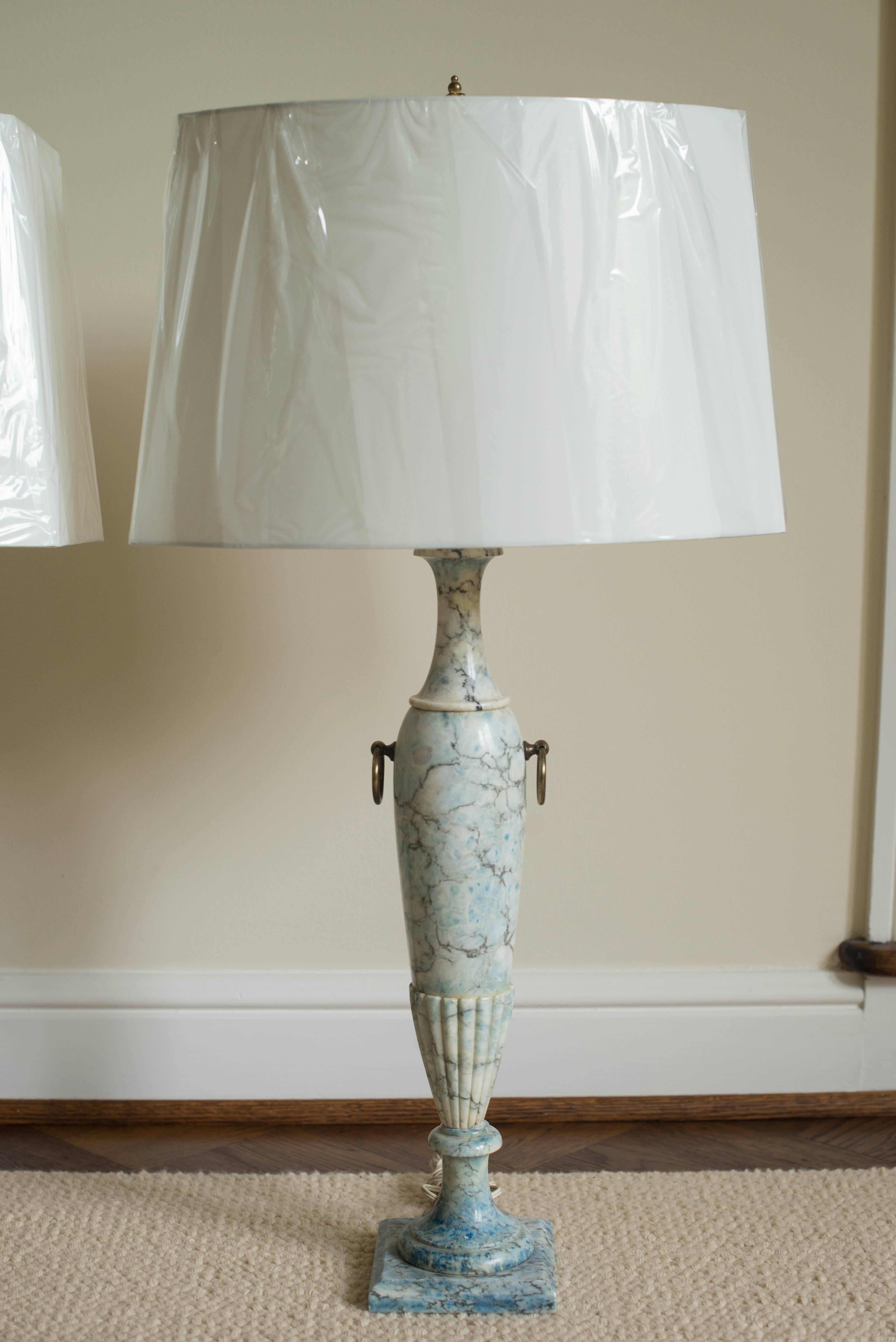 This fabulous pair of Midcentury carved blue marble table lamps comes with the new silk shades and brass finials shown in the photos. The blue marble is highly unusual but perfect for today's color trends and decor. The height of the lamps is 25.5