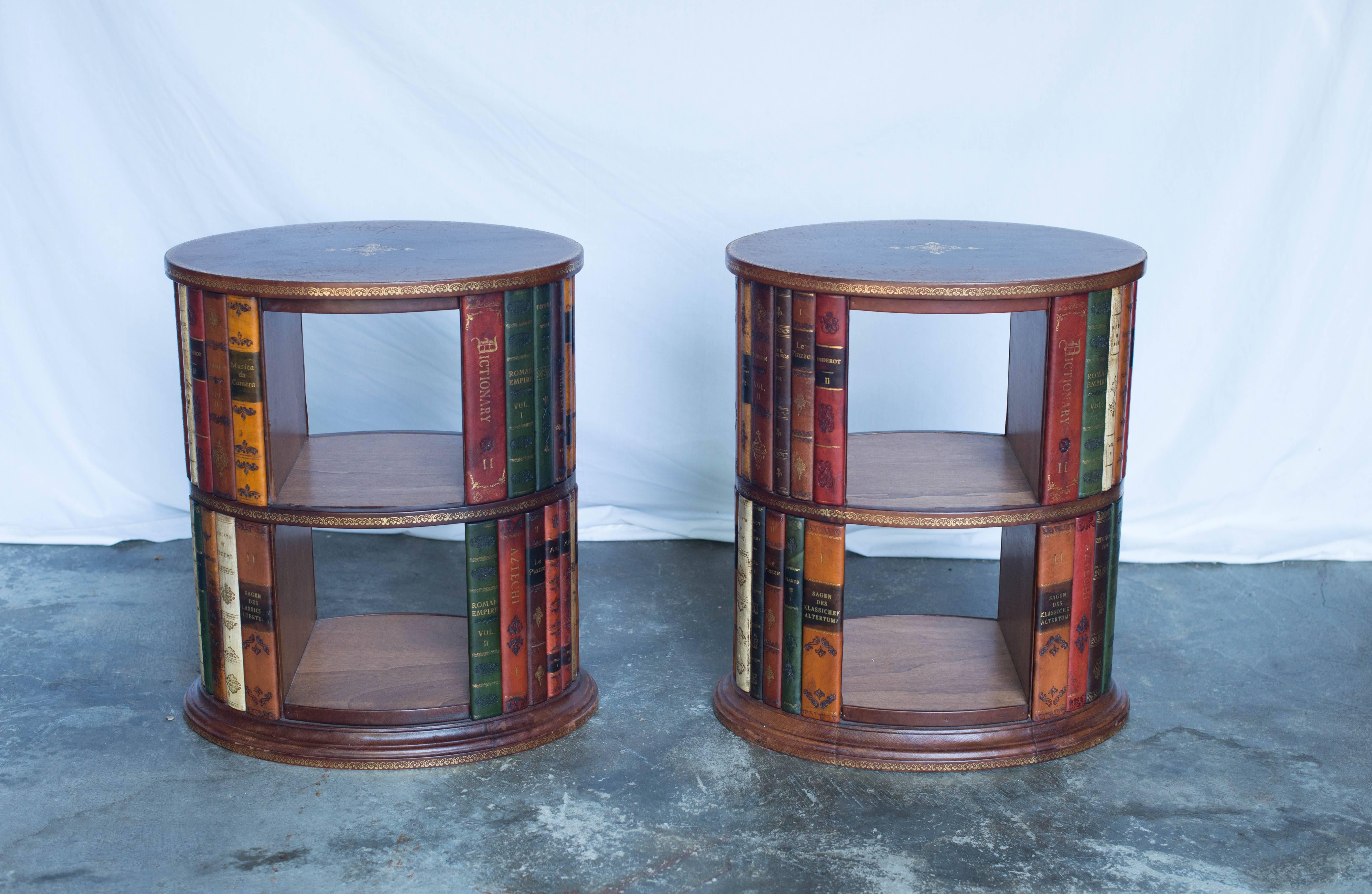 This pair of Italian hand tooled leather side tables features a leather bound book motif. The leather is a lovely brown with gold accents. The shelves are made from wood.
