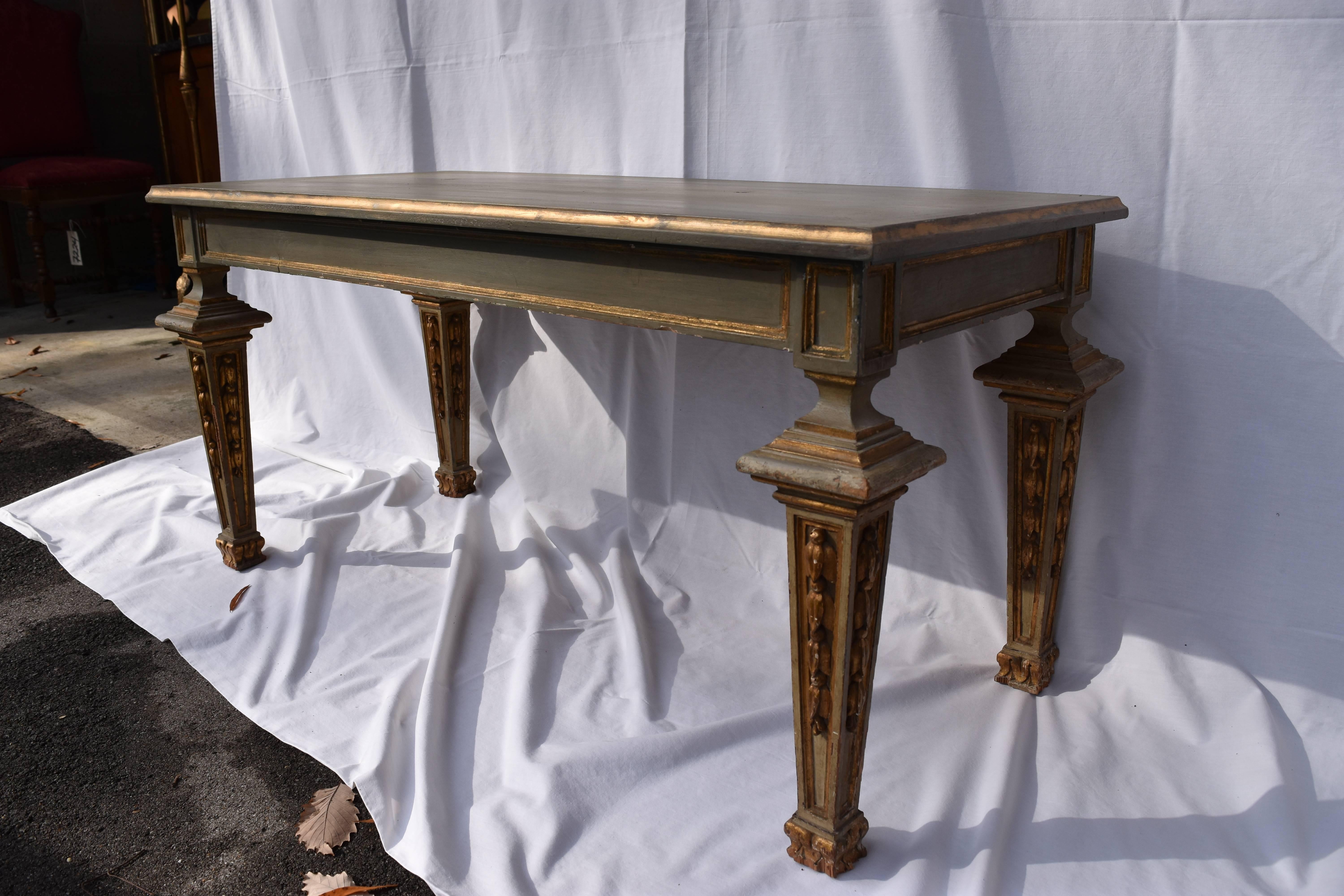 Late 19th century painted Louis XVI style coffee table. The finish is a muddy green color with gilt accents. There is some minor wear or paint chipping to the bottom of several of the legs.