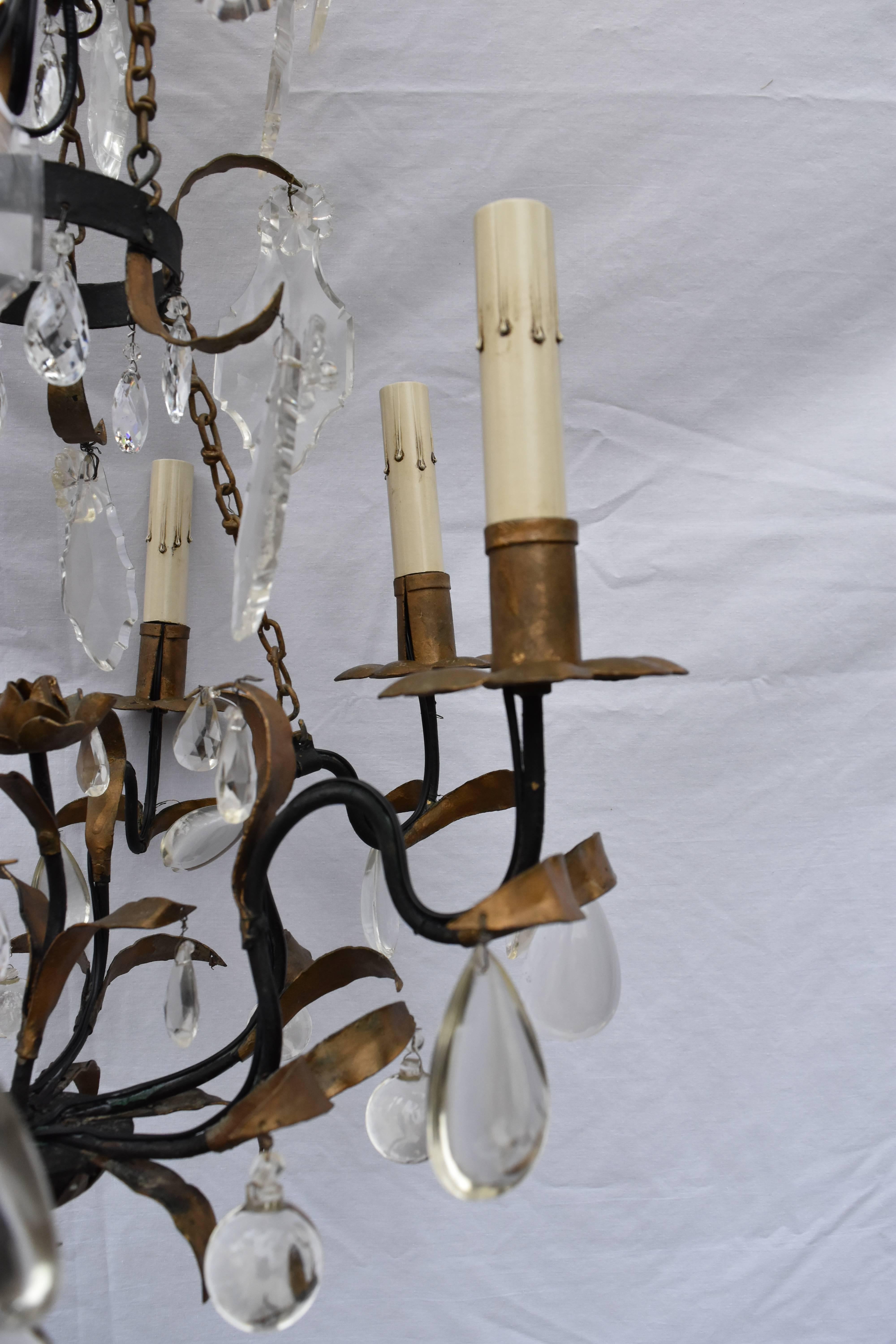This French crystal and iron six-arm chandelier has a bronze and gilt finish with leaves embellishing the arms and a rose coming up through the centre. It has been newly rewired and cleaned.