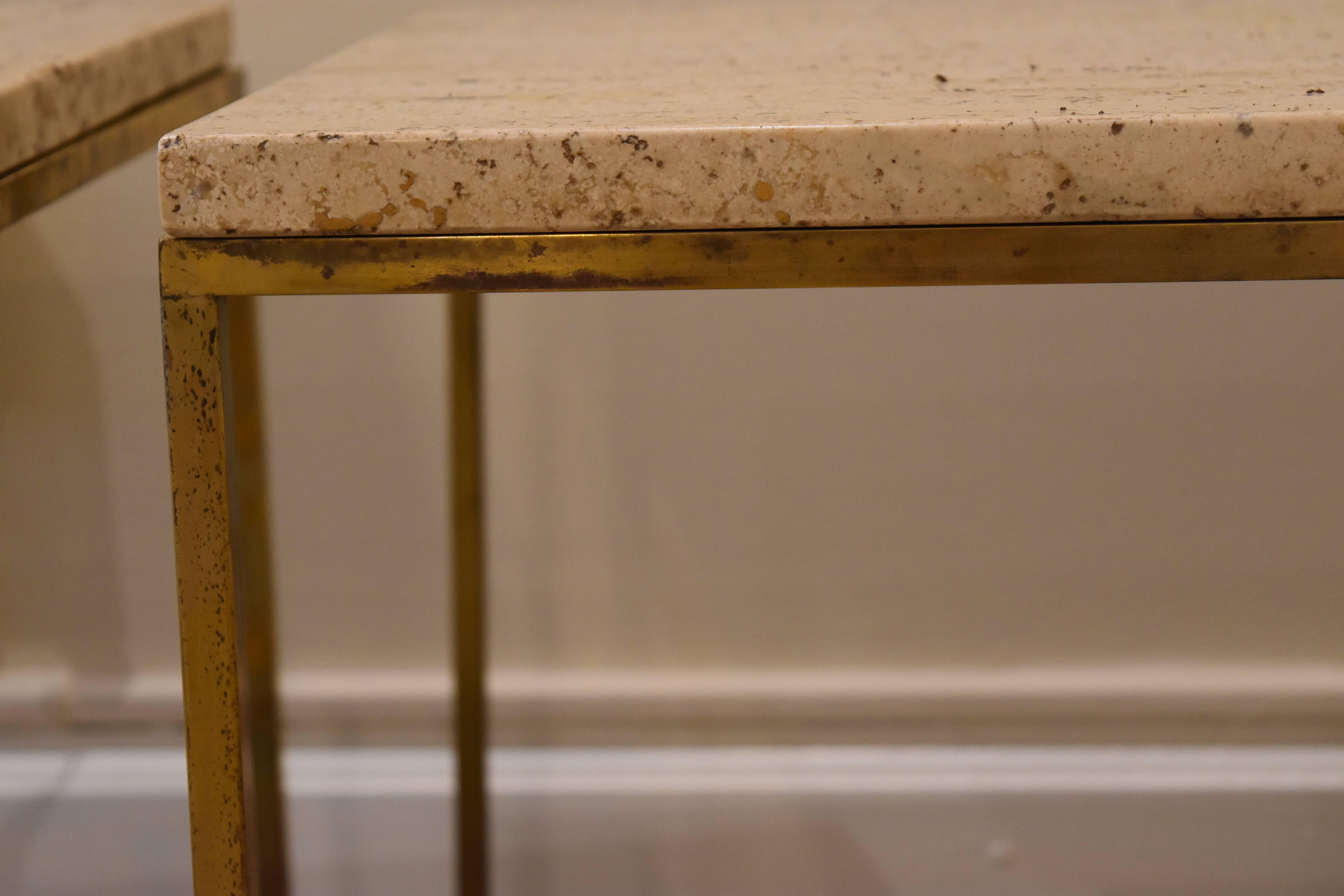 This set of three Mid-Century brass and travertine tables may be attributed to Paul McCobb. The brass has a beautiful patina and the travertine is in excellent condition. Together they could be used as a coffee table on individually as side
