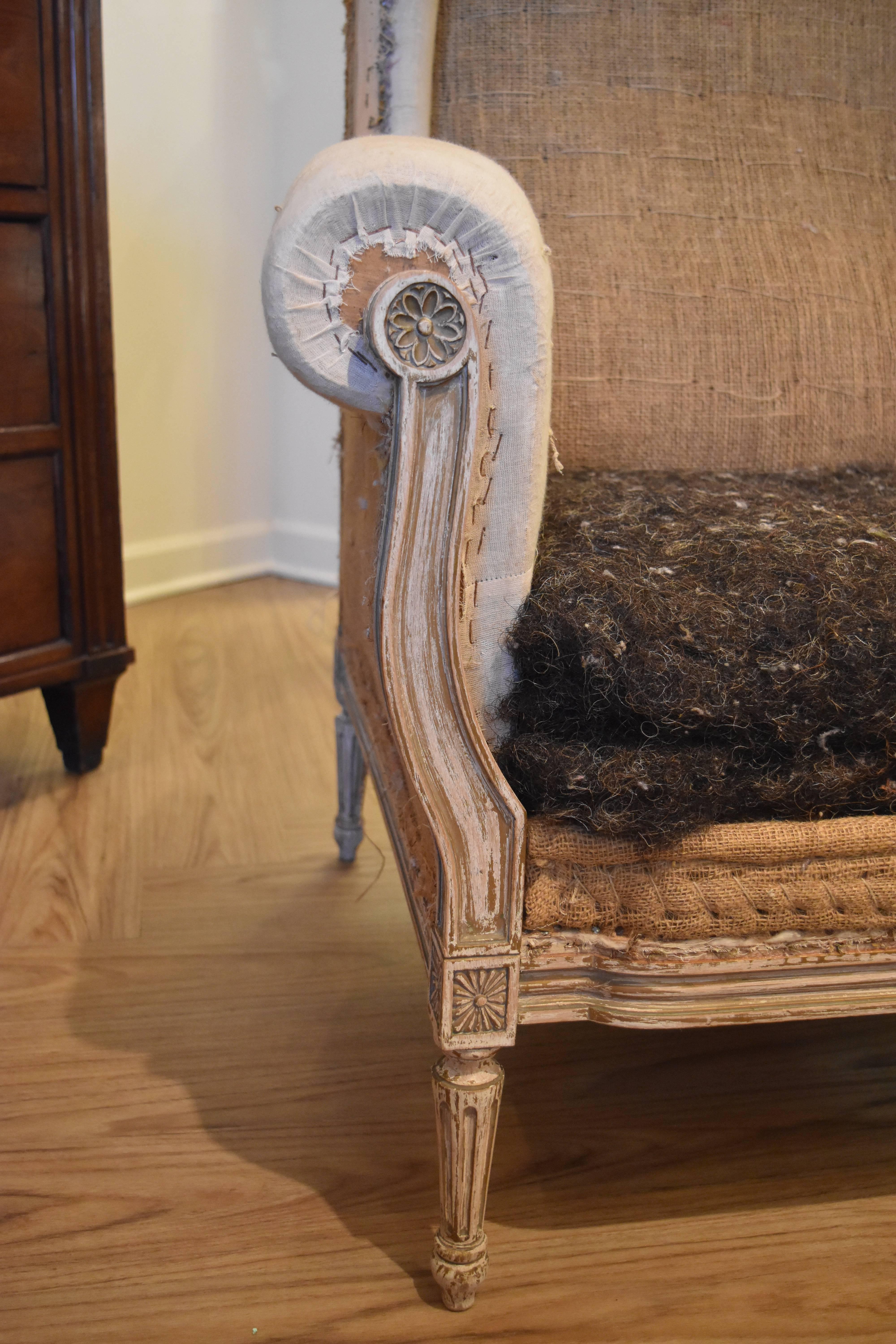 This pair of 19th century French wingback chairs have a lovely painted cream finish. As shown in the photos, the chair seat cushions still have the original horse hair covering and need to be upholstered.