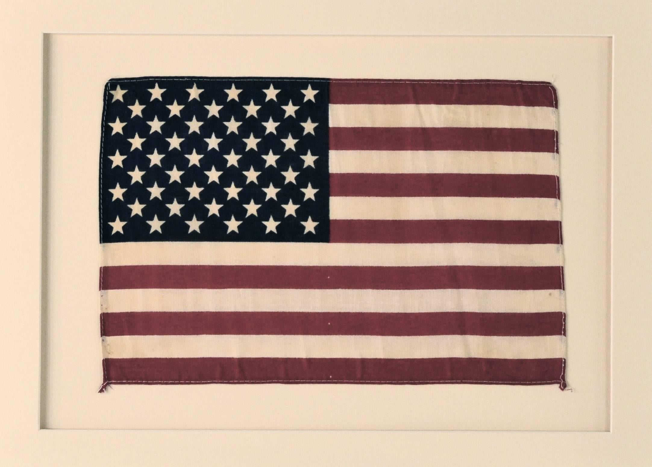 Vintage 50 star flag made of printed cotton. This flag was saved when the 50 star flag first appeared in 1959.
Conservation framing with UV acrylic.
                                     