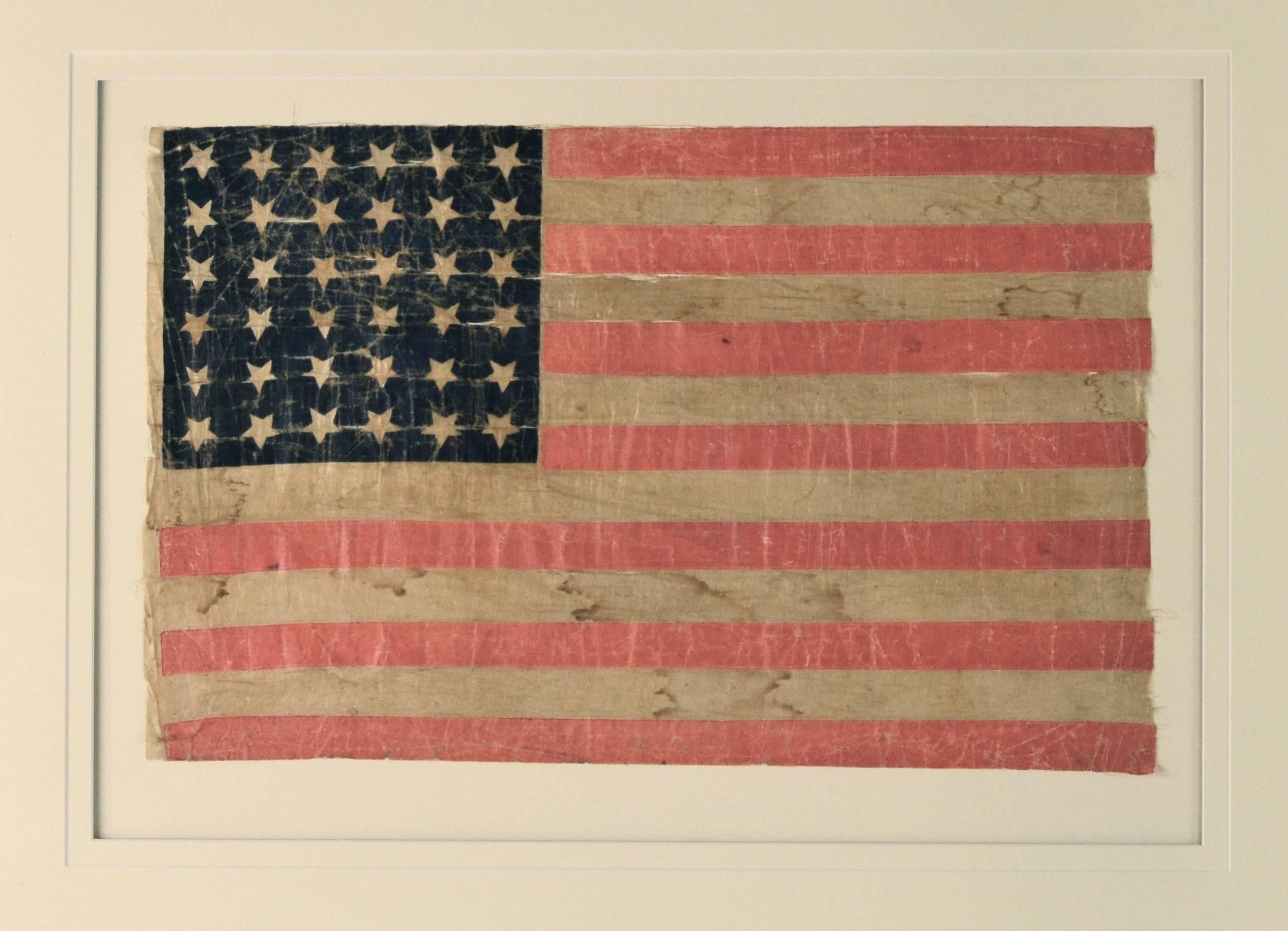 Authentic antique 36 star flag made of starched glazed fabric. Made during the Civil War, circa 1864. Civil War flags are fairly rare and highly collectable.
Conservation framing with UV acrylic.
                          