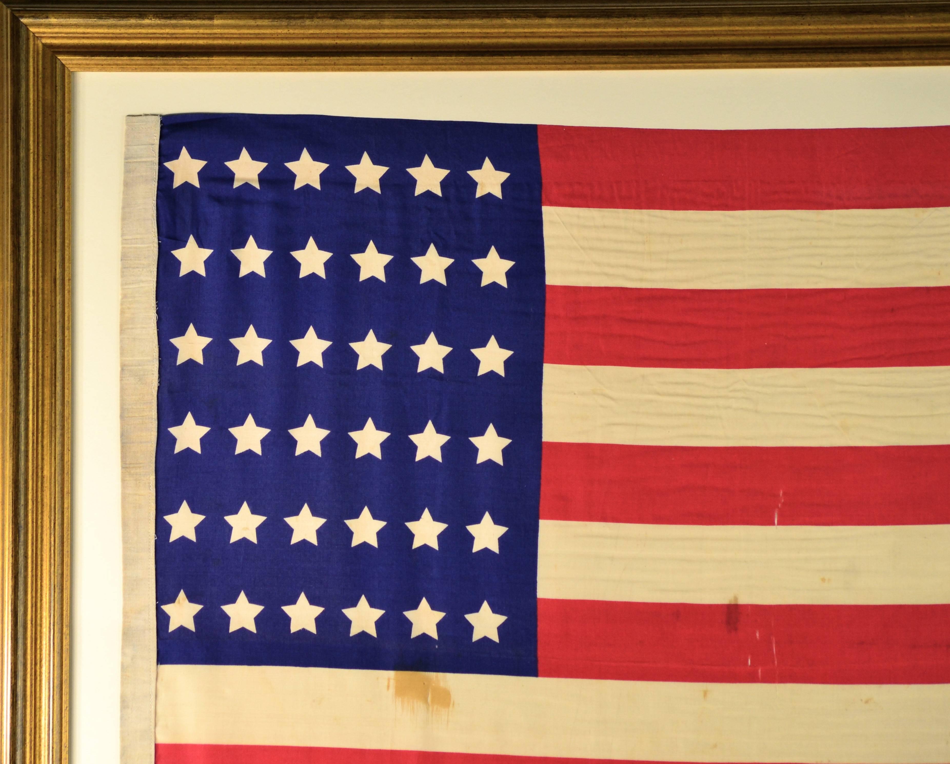 Civil War Regimental flag with 36 stars, circa 1864. Made of silk with linen sleeve hoist. Very rare size proportion for the canton as its very narrow. Official US Army silk Regimental flags of the era were 36