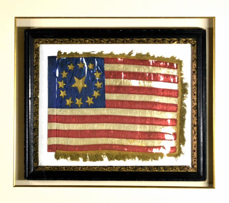 Very rare and desirable antique flag for the discriminating collector. Made of individual hand cut and hand-sewn silk stripes and individual hand-painted gold stars. It has period fringe on three side which is also hand-sewn on. It has a