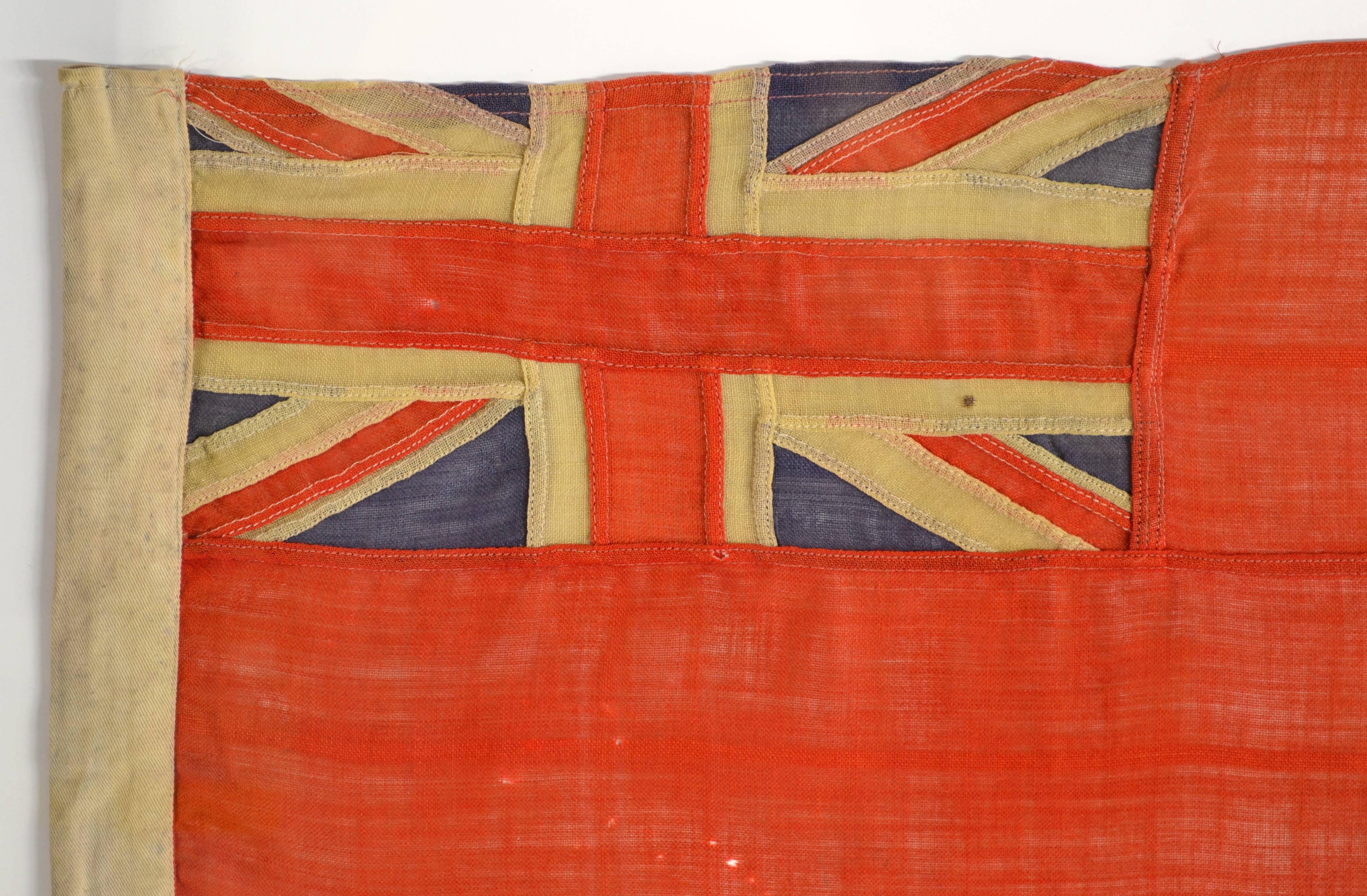 British Red Ensign.

Authentic rare antique hand-sewn British Red Ensign. Individual hand-cut and hand-sewn individual sections and panels. Made of wool. Nice rare flag.
The Red Ensign (red field with the Union Flag in the canton) defaced by a badge