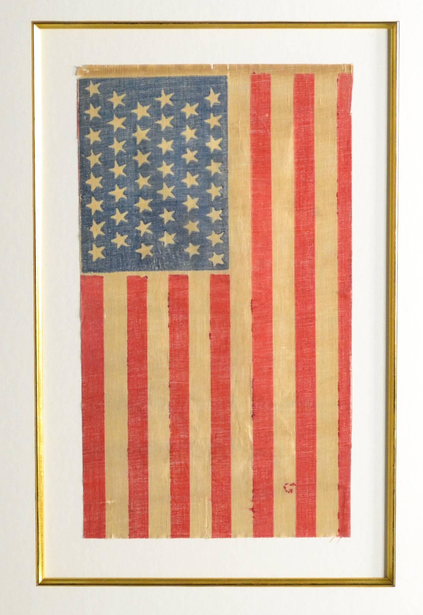 Great looking antique 44 star flag from 1890. Double sided flag. We framed it to hang vertical, the canton (blue part) always must be at the top left of any hanging flag. Made of a starched linen fabric. Grover Cleveland was President. Measures: