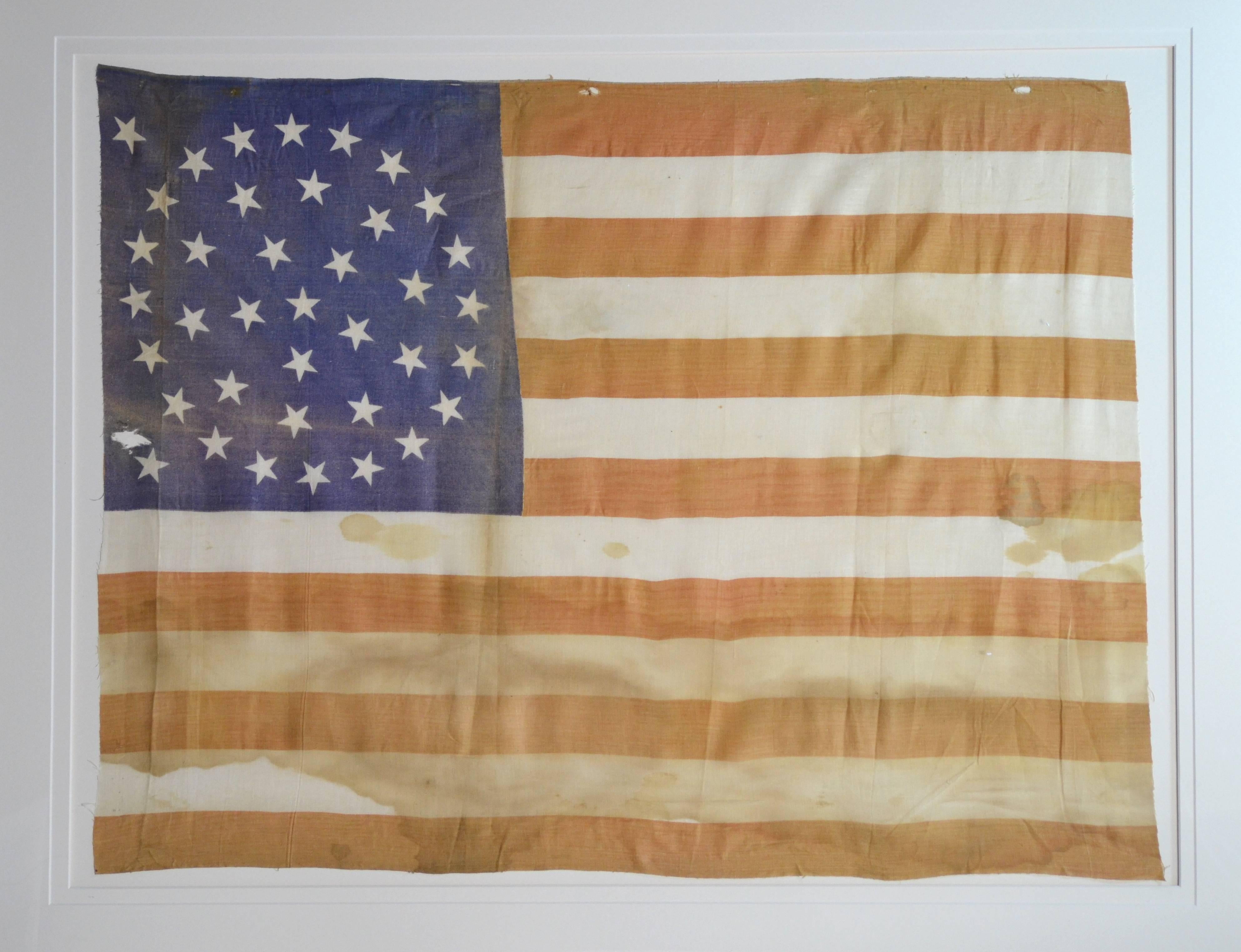 Rare Antique 38 Star Flag, circa 1876, with rare star arrangement called a triple wreath medallion with no center star. Made of printed cotton. Some staining and fading, but its still a fantastic flag which is a great piece of art. Flag size