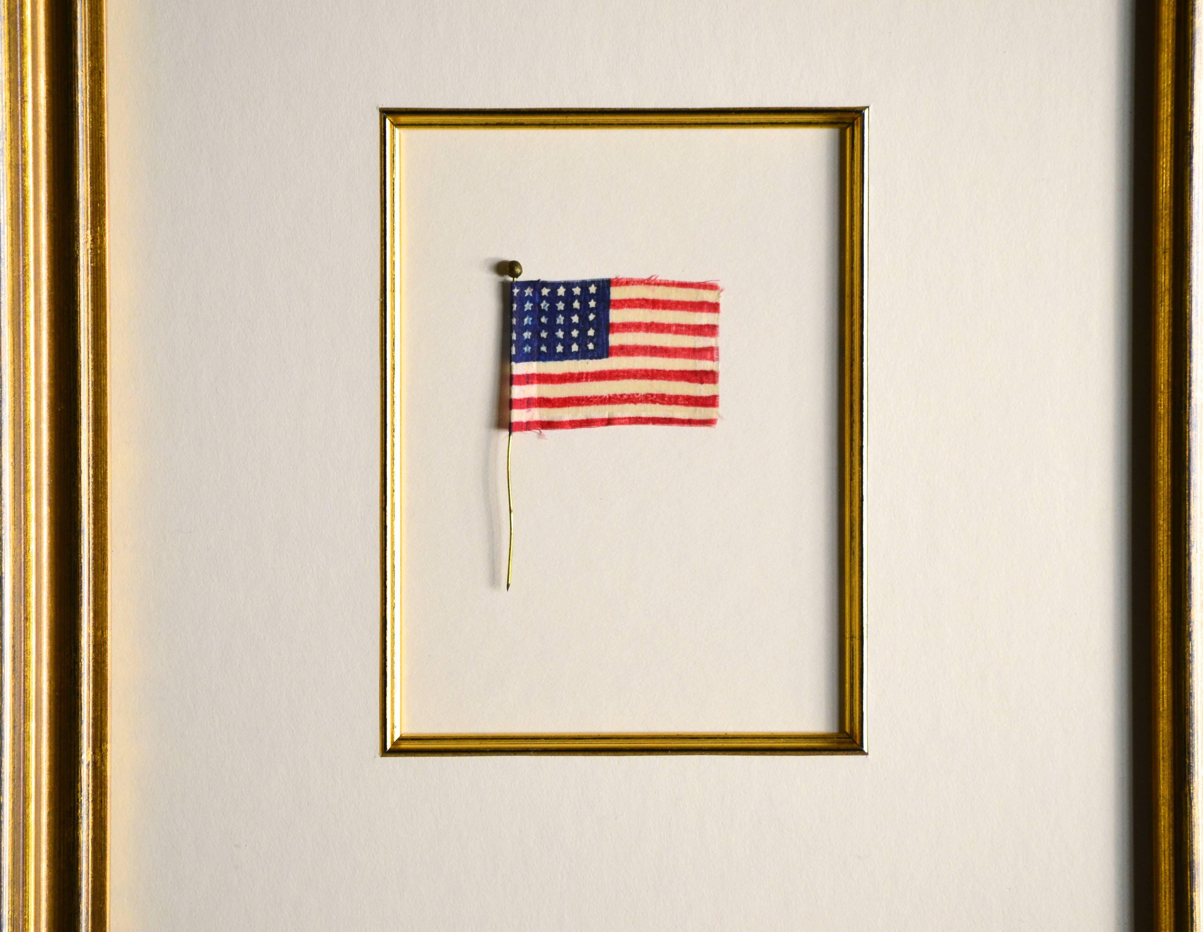 Antique 30 star flag made of silk attached to a brass pin. This would have been used as a hat / bonnet pin or a lapel pin. Beautiful colors, circa 1848. Zachary Taylor was President. Frame is 12