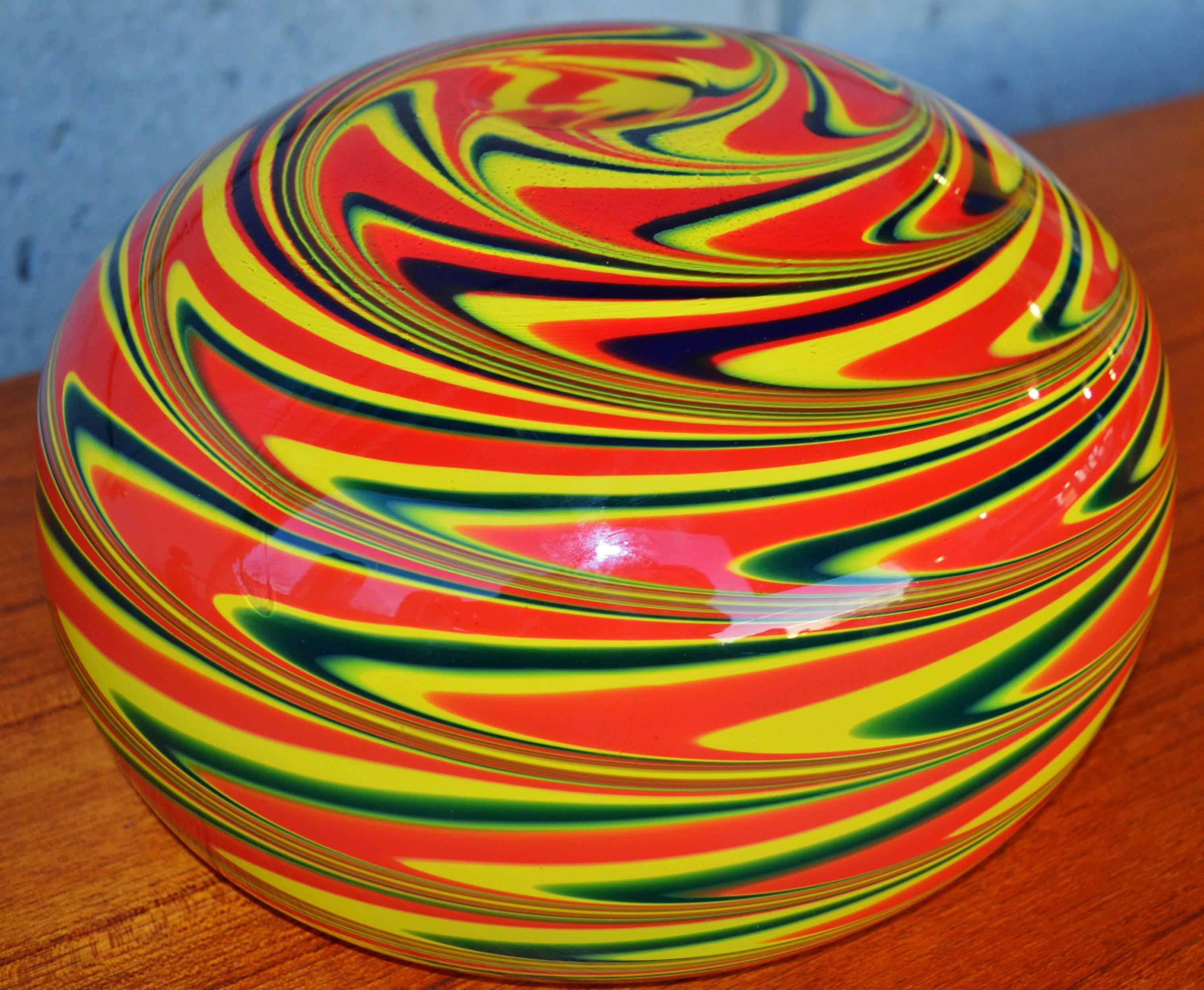 The drama of this large-scale and heavy Murano handblown glass bowl with it's vivid swirl pattern in red, green and yellow, cased in yellow, is hugely impactful. A center piece sure to be noticed and remarked upon.