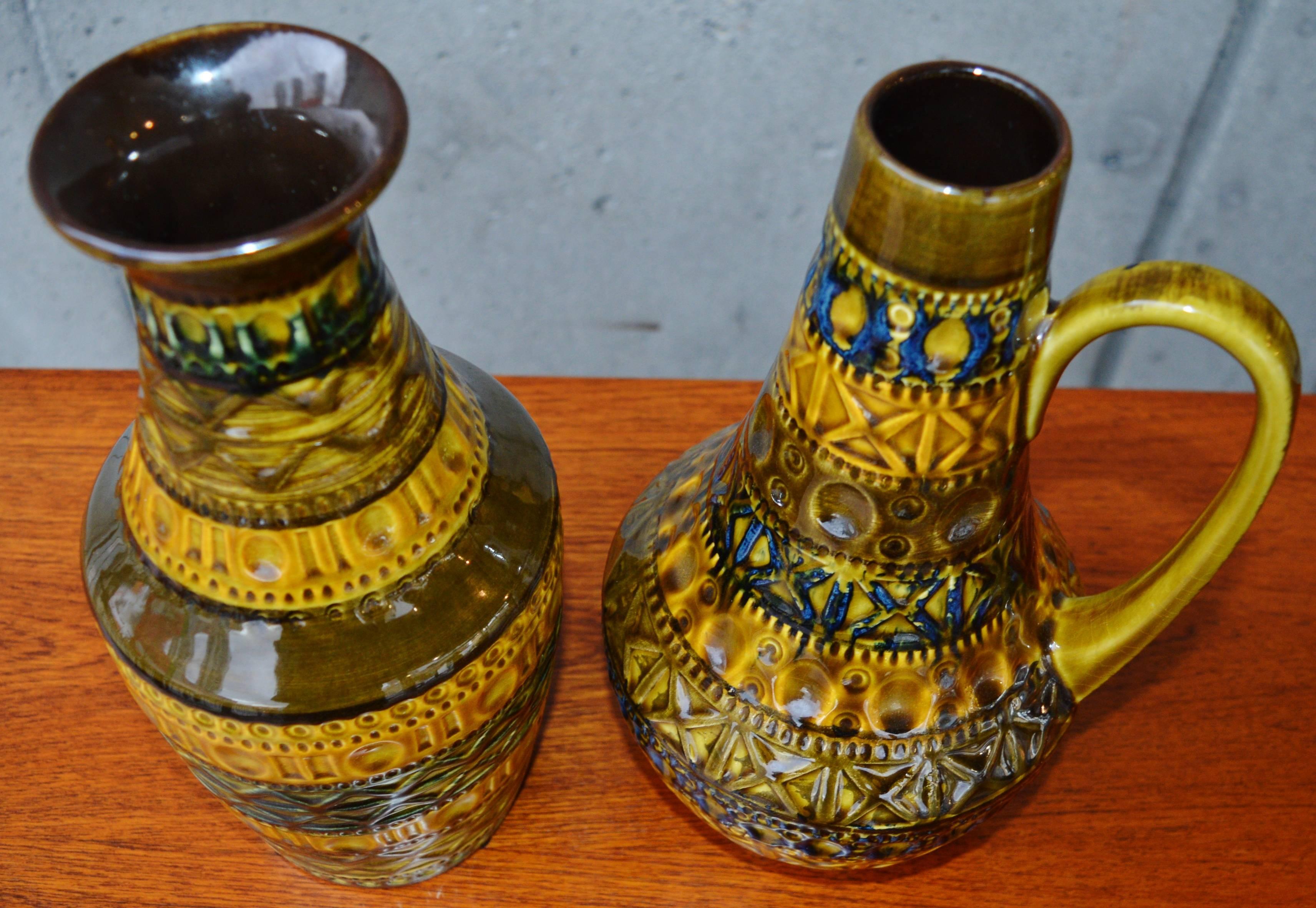 This striking pair of West German Mid-Century Modern accent pieces are in a gorgeous palette that will complement any decor. Beautifully constructed and textural, one a vase, the other a pitcher, both were designed in the 1960s and made by Bay