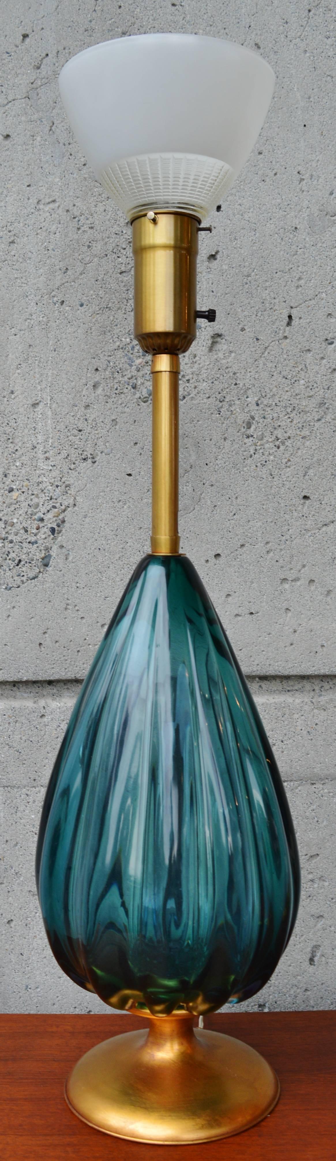 This eye pleasing peacock blue scalloped glass lamp is monumental in size and style! Designed by Archimede Seguso for The Marbro Lamp Company. Featuring a gilt mahogany base and stem - still with the original sticker bearing the motto: Old World