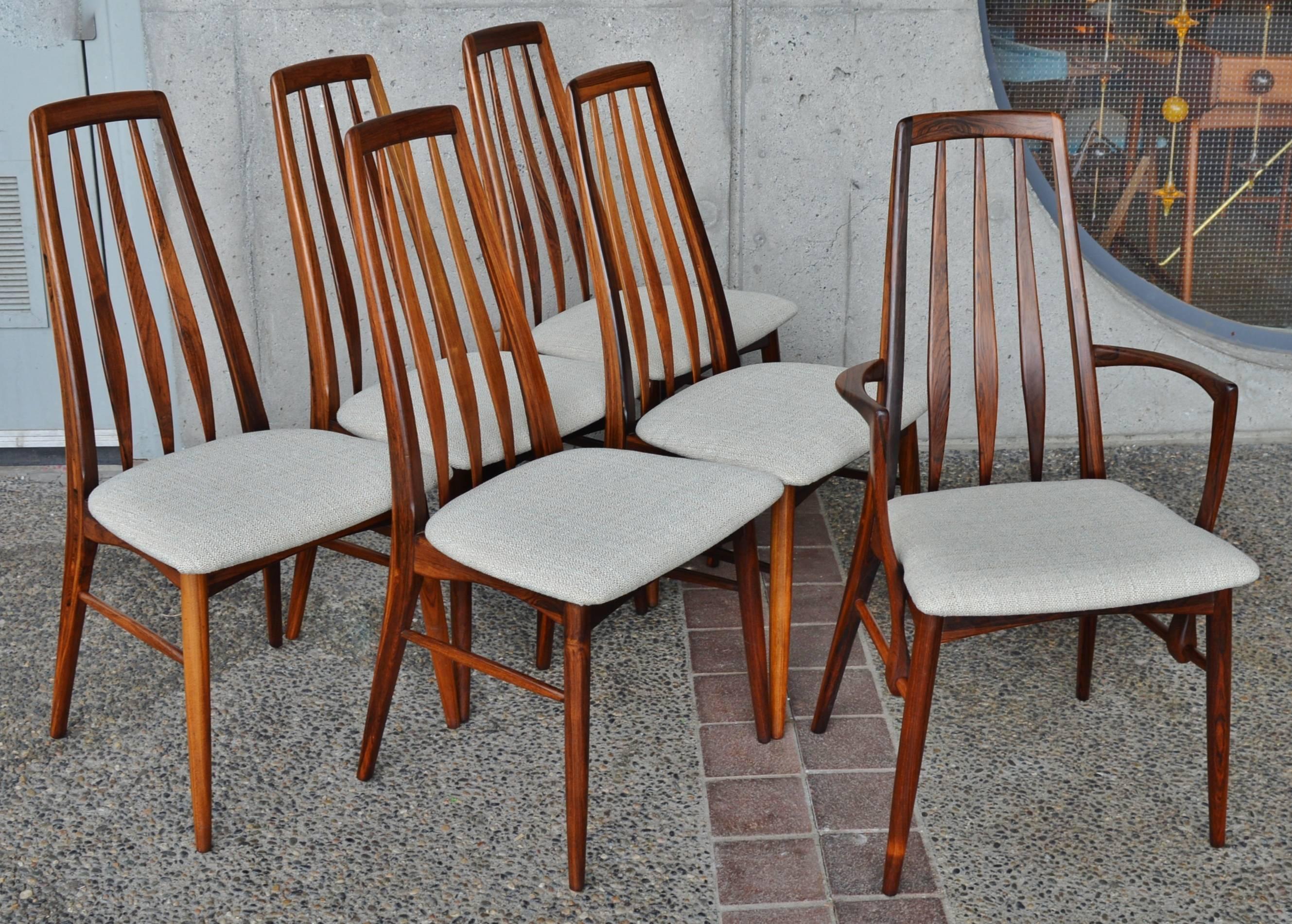 This impeccable Danish modern rosewood dining set was originally purchased together in the 1960s and is in excellent condition. Featuring an incredible sculptural double pedestal two-leaf oval dining table by N. O. Moller paired with a set of six