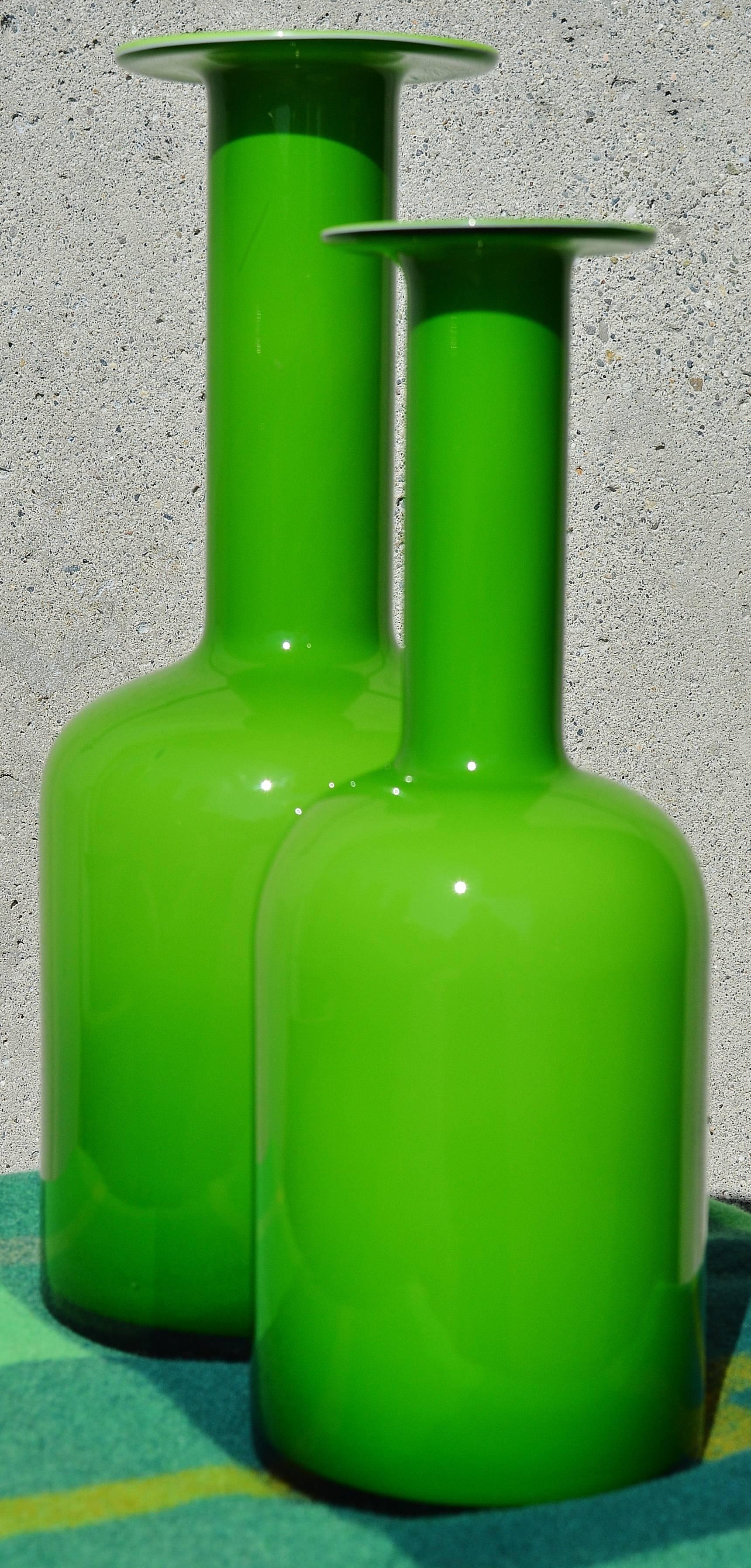 These iconic Danish Modern handblown art glass vases are in the most delicious shade of green that will be a gorgeous pop of color in your decor that will complement plants as well as nature. Designed by Otto Brauer for Holmegaard, they are in