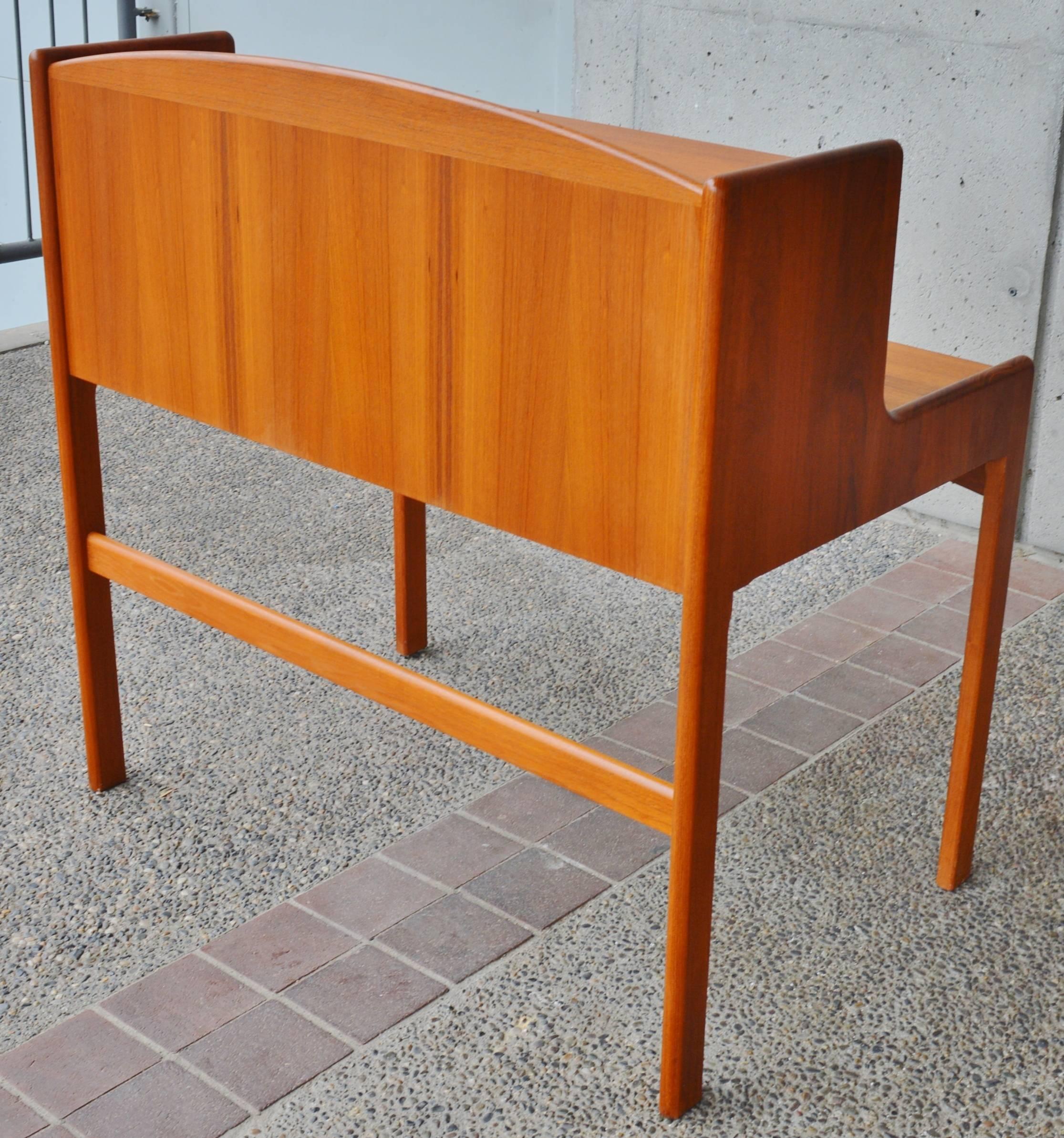 This extremely rare Danish Modern teak step-back desk / secretary is completely solid teak throughout - even the drawer bottoms! Note the photo of the sides of the desk - where you can see the grain wrap right around the edges. The drawers are solid