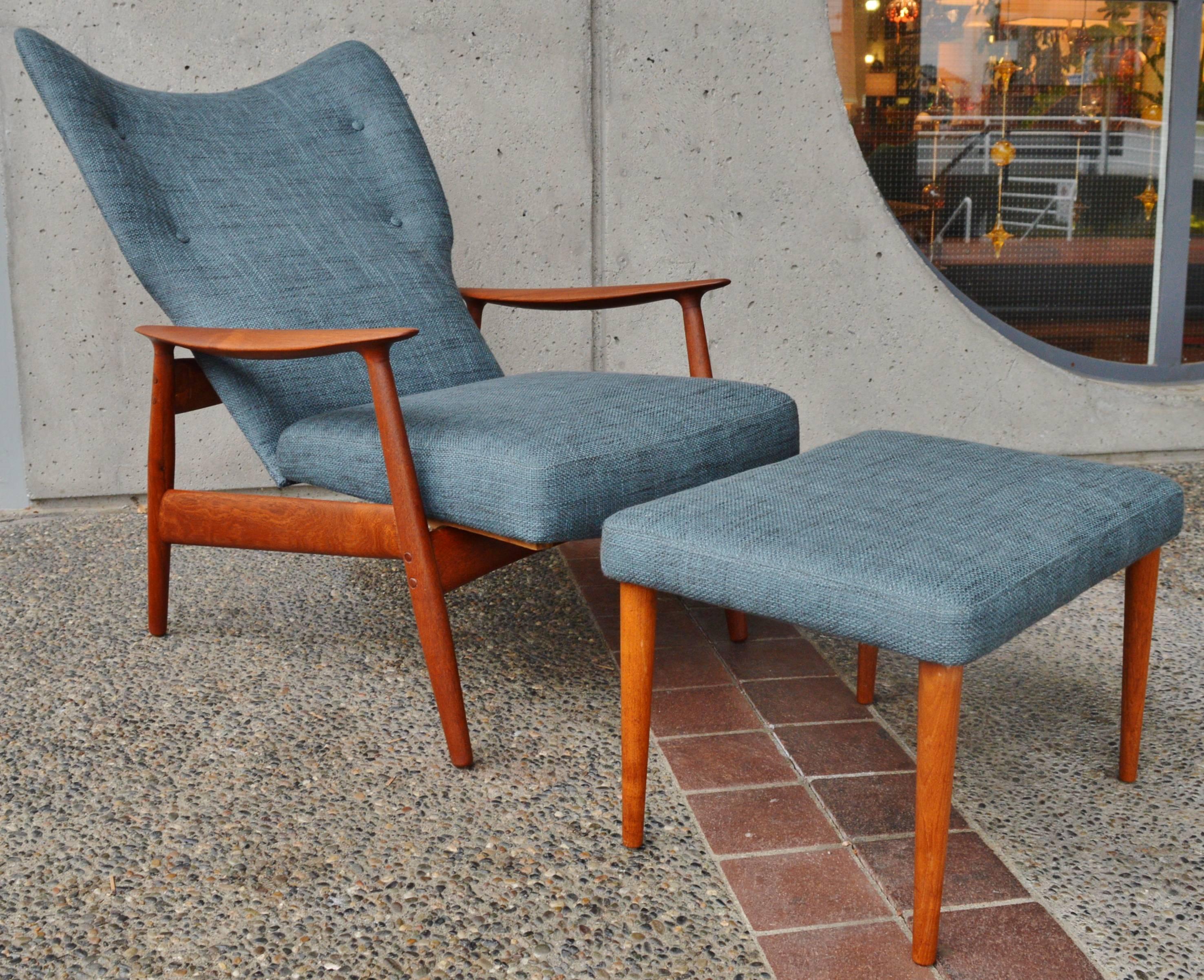 This totally killer Danish modern teak frame recliner and ottoman are a rare example designed by Peter Wessel. Featuring sultry sculpted armrests, a beautifully contoured teak frame with conical legs that match the ottoman, and totally restored and