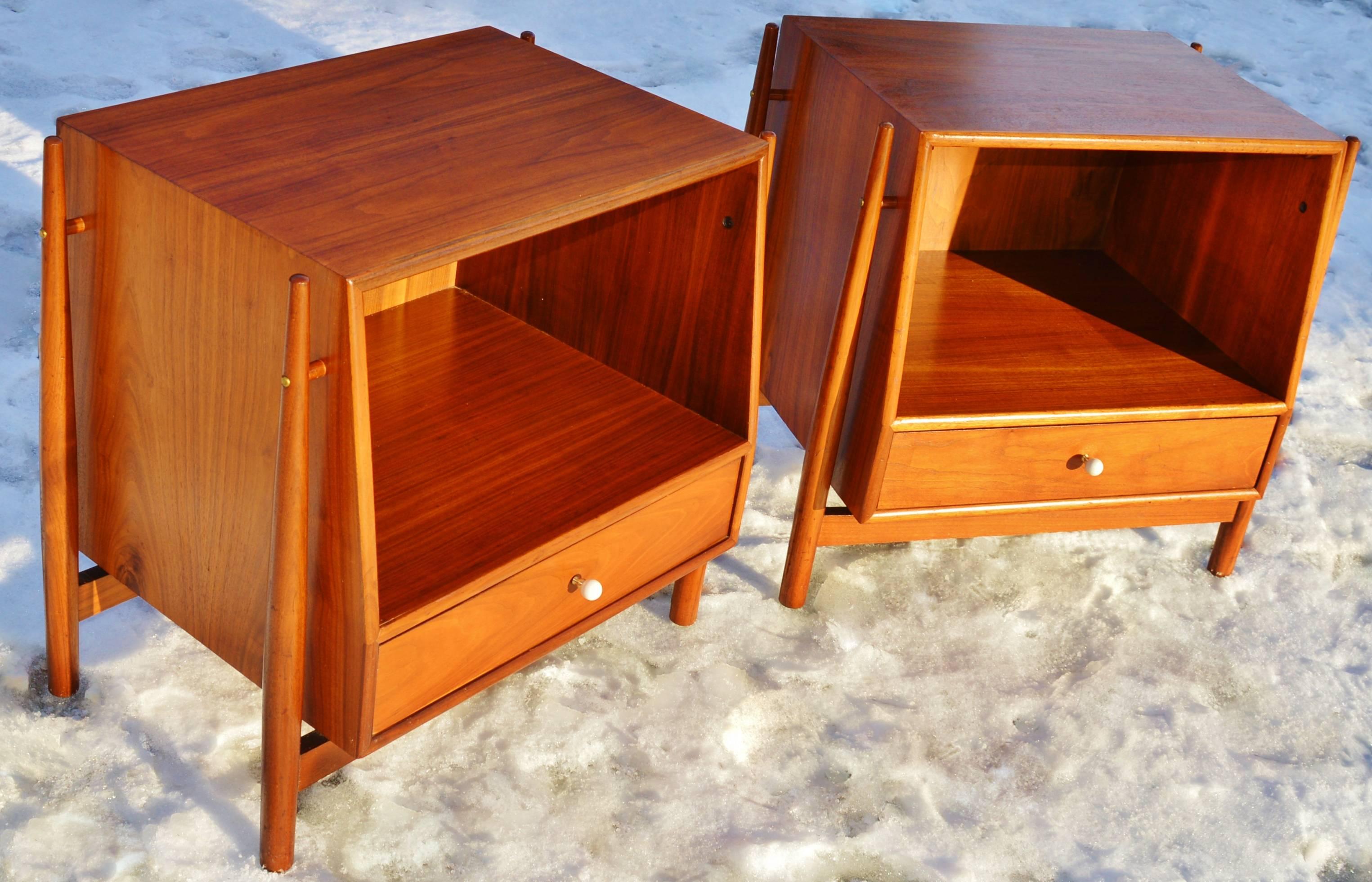 These walnut side tables or nightstands are the most coveted of the Drexel Declaration line by Kipp Stewart and Stewart MacDougall in the 1950s. Featuring the exposed exoskeleton structure that supports the floating cabinets that have angled fronts,