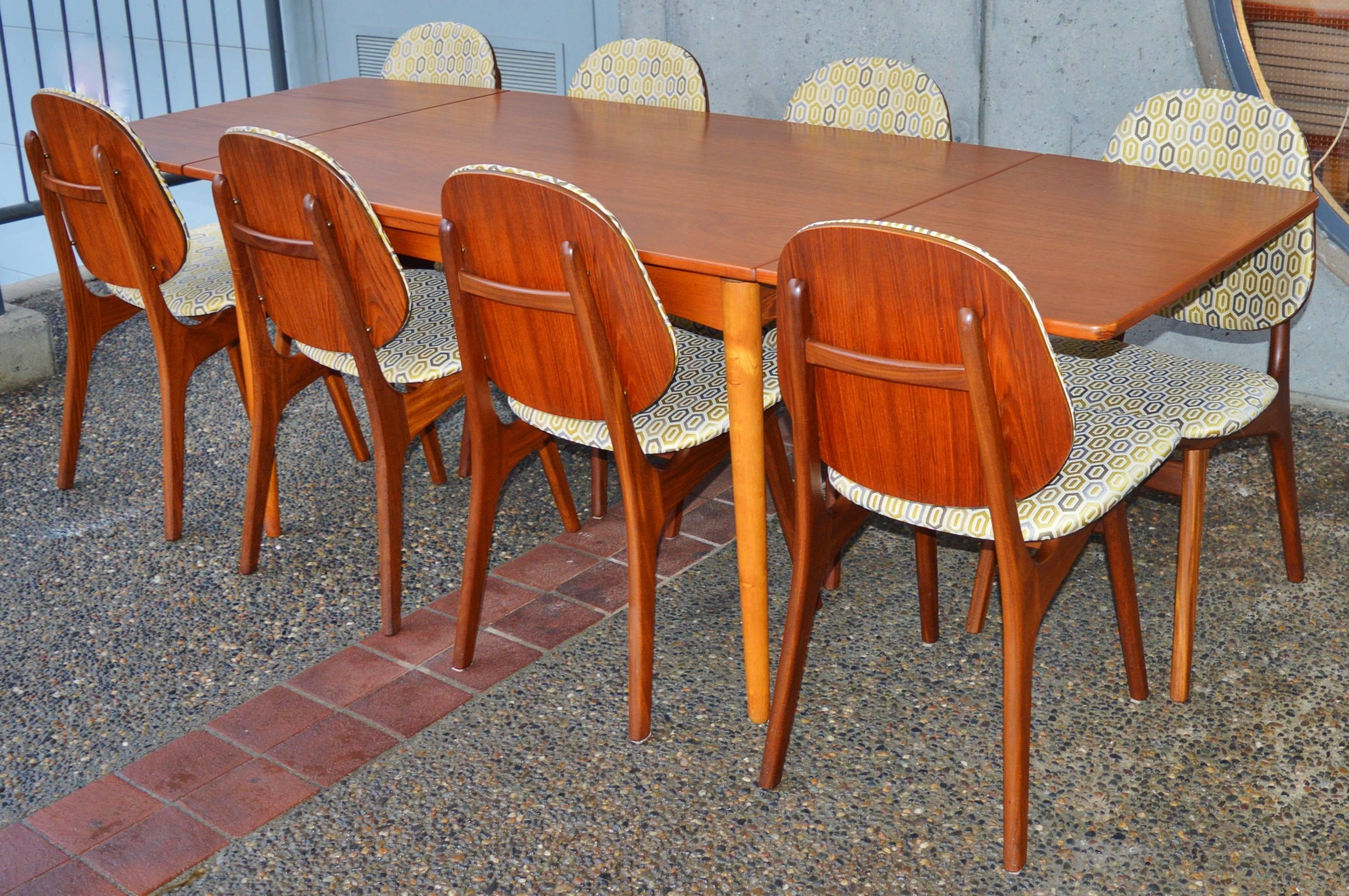 This is a totally gorgeous set of eight Danish modern teak dining chairs by Arne Hovmand-Olsen, completely restored and reupholstered with new foam and a wonderful modern high end graphic upholstery. I love the floating wood 