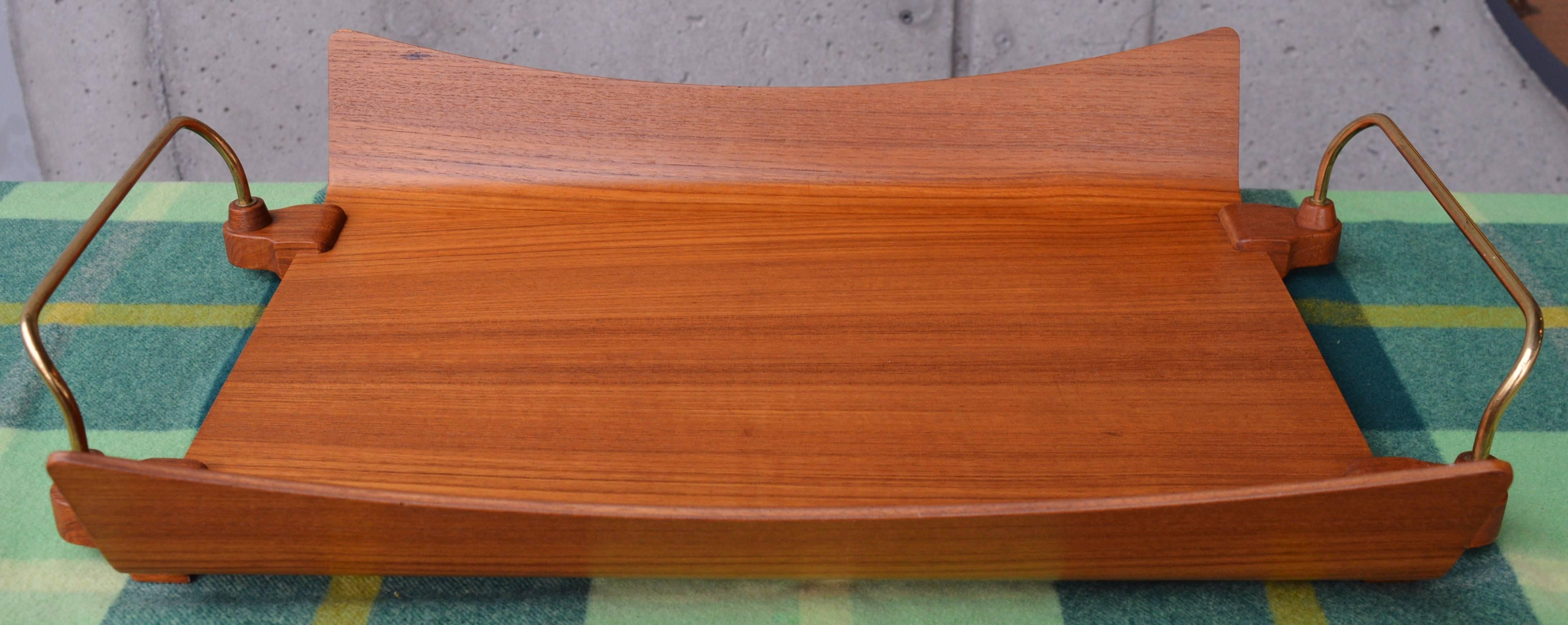 This unusual, large Danish modern teak tray is a beauty in amazing condition. Despite its unique style, we were unable to identify the designer, although by experience, the quality construction is undoubtedly Scandinavian. Featuring flared and arced