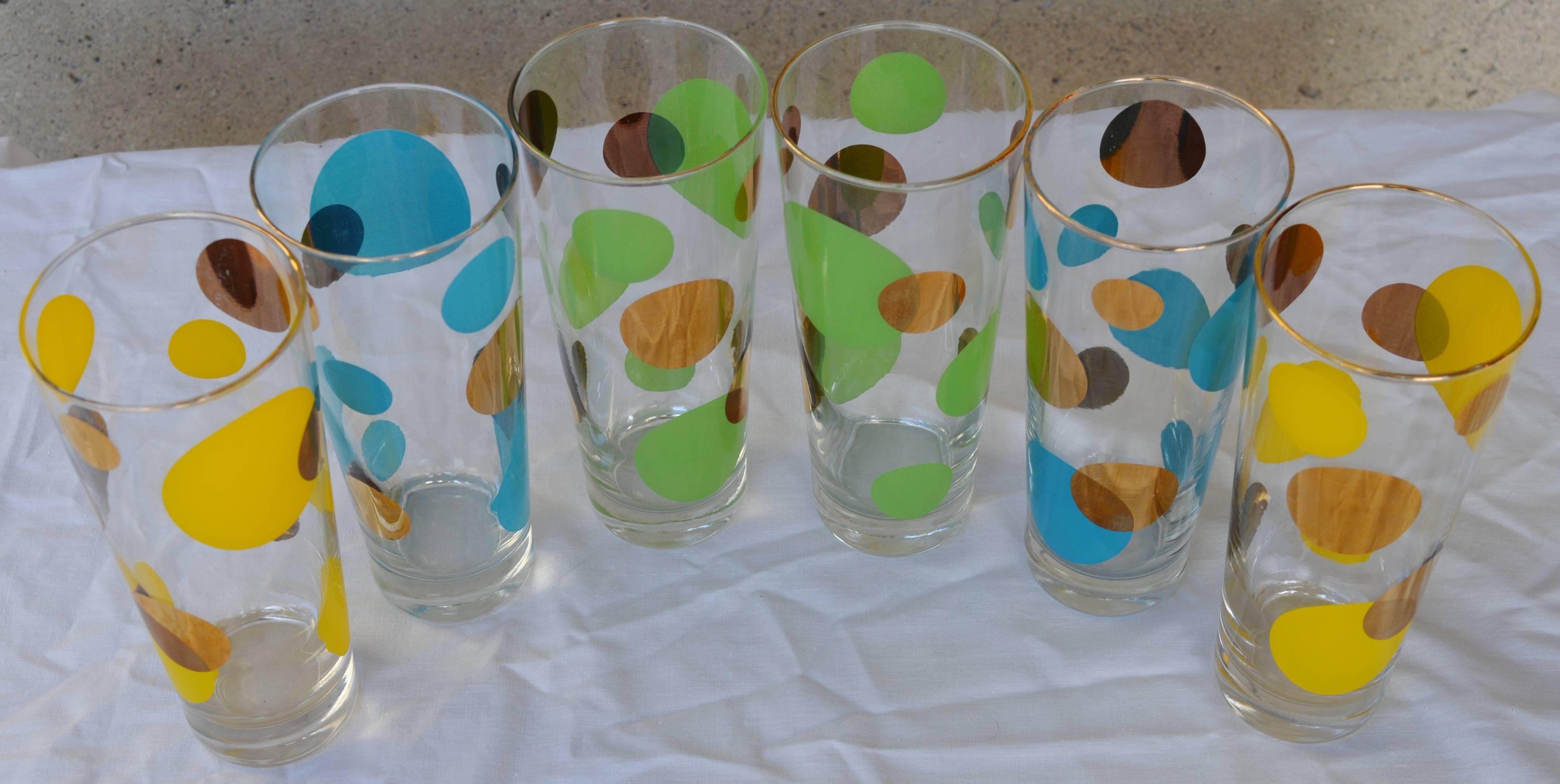 A fantastic set of vintage barware designed by Russel Wright for Bartlett-Collins. This 1950s Atomic Era styled set consists of six hi-ball glasses, two of each in yellow, green and blue with gold. The pattern is clear, sharp and unfaded and