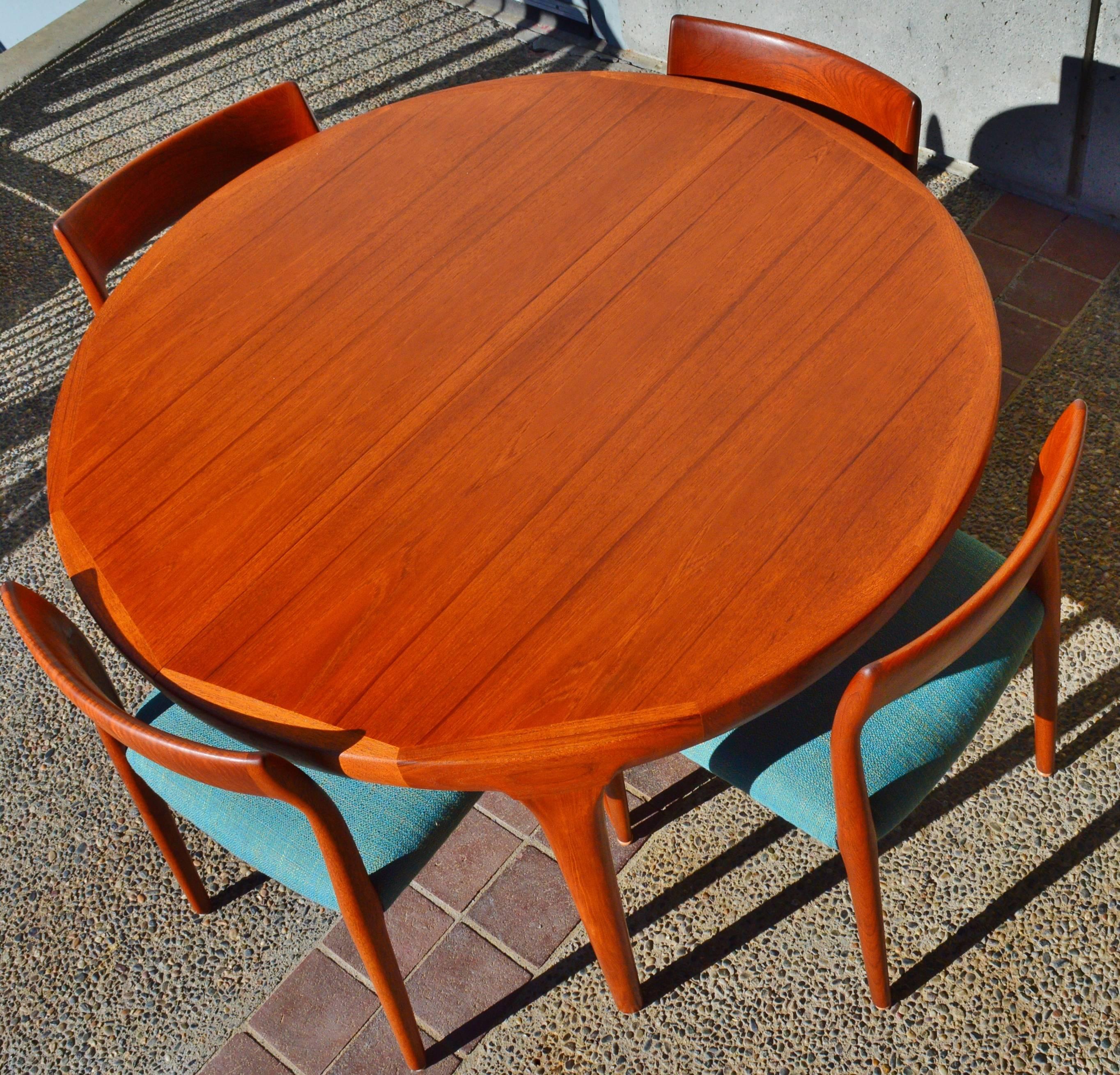 This stunning set of four Danish modern teak Model #77 dining chairs were designed by Niels Otto Moller for JL Moller. Beautifully constructed, sultry lines and a wonderful rich patina. Restored and reupholstered with new strapping, foam and a