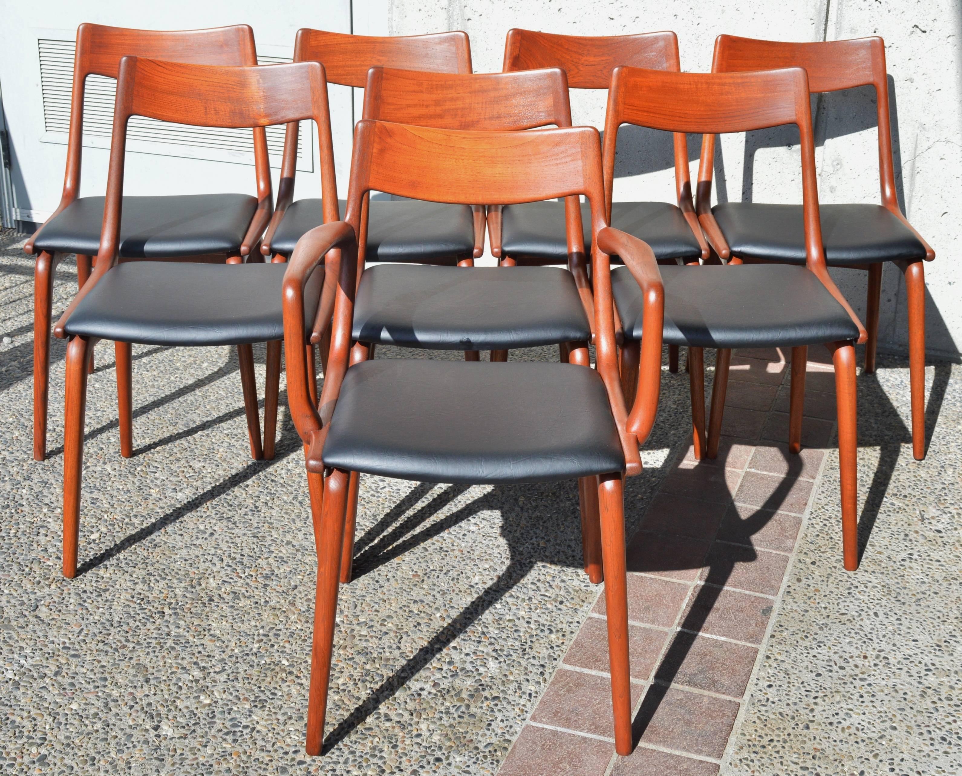 This impeccable set of eight Danish modern teak dining chairs were designed in the 1950s by Erik Christensen for Slagelse Mobelvaerk. Known as the boomerang chair, with it's iconic boomerang shape that runs from the side of the seat up to the
