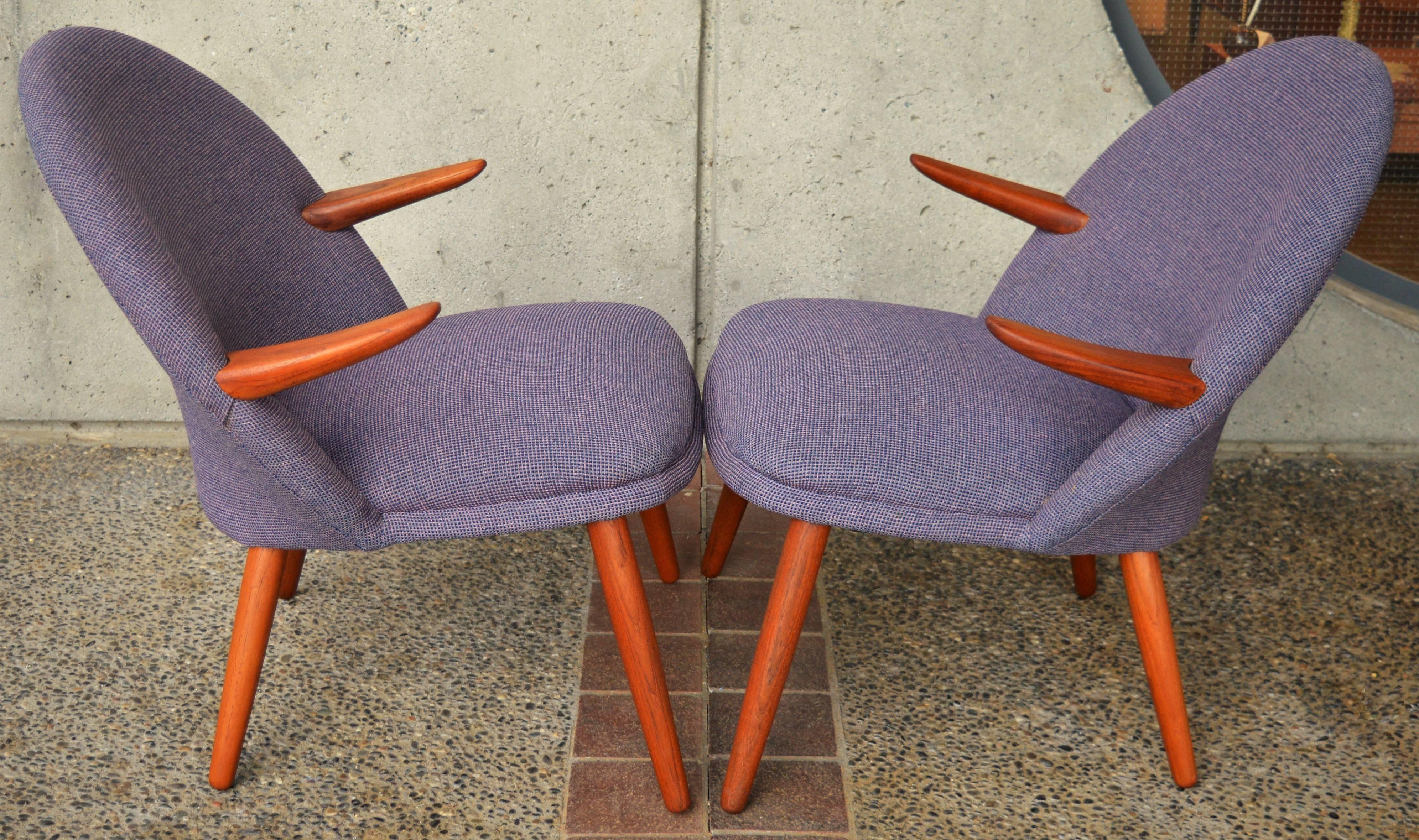 This delightful pair of whimsical Danish modern teak lounge chairs are a more petite profile, yet superbly comfortable. The playful teak armrests give them amazing character. Designed in the 1950s by Kurt Olsen for Glostrup Mobelfabrik. The recent