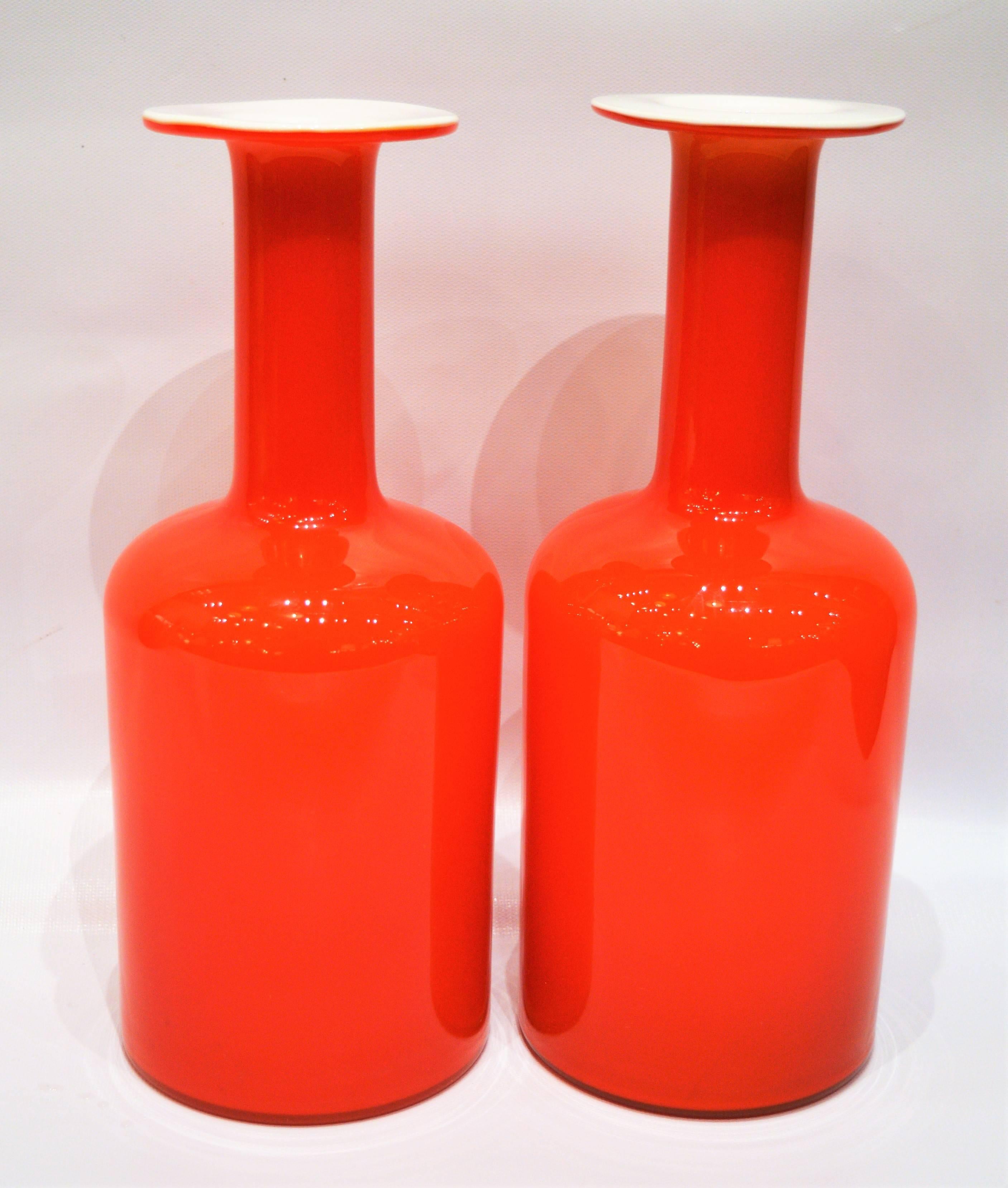 These iconic Danish modern handblown art glass vases are in the most delicious shade of tomato orange that will be a gorgeous pop of color in your decor. Designed by Otto Brauer for Holmegaard, they are in excellent condition with no chips, cracks
