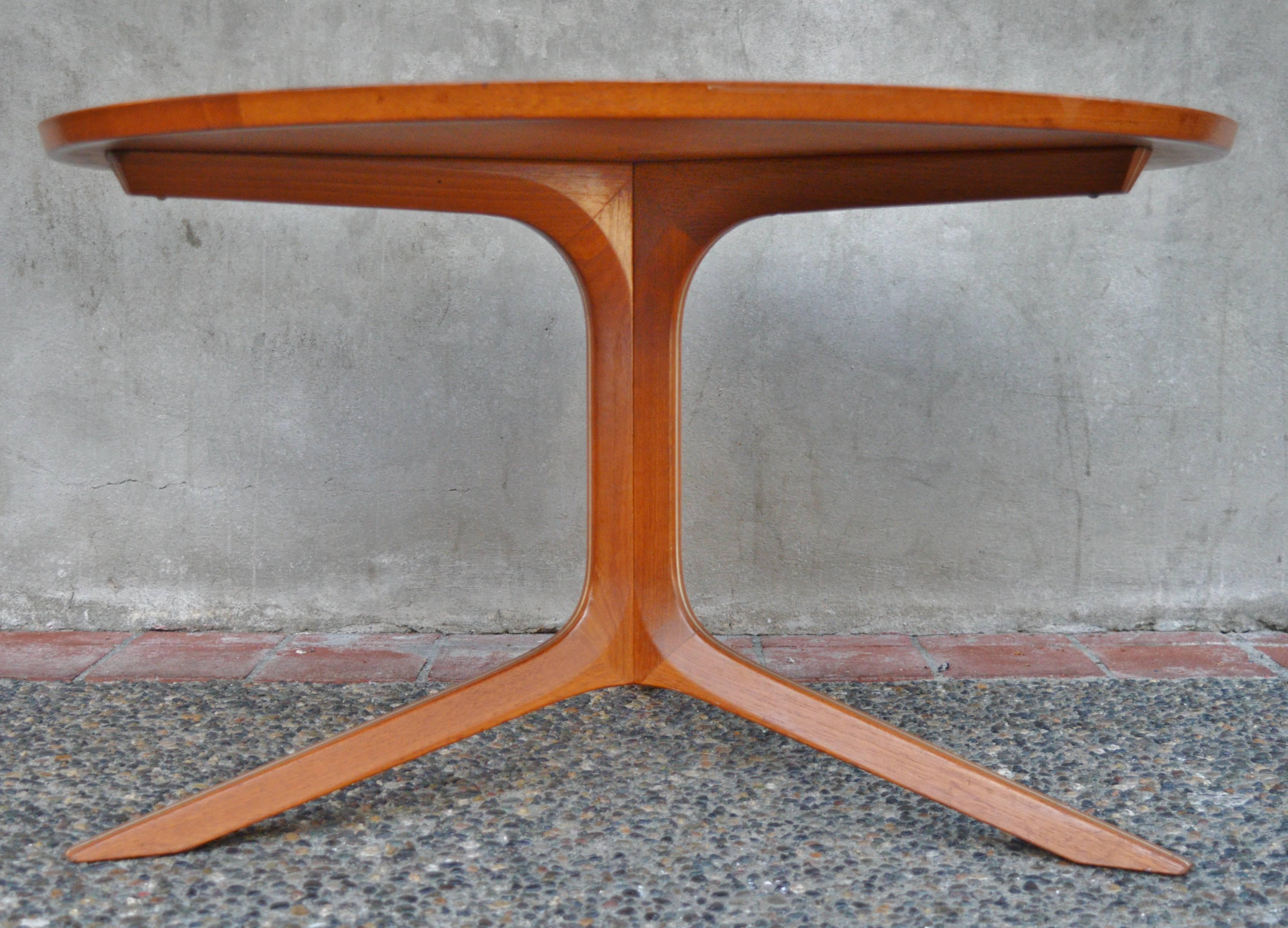 This lovely and rare, more compact round teak coffee table was designed by Peter Hvidt & Orla Mølgaard-Nielsen for France & Son in the 1960s. Part of their silver line series of tables and seating - note the aluminium strip that is sandwiched