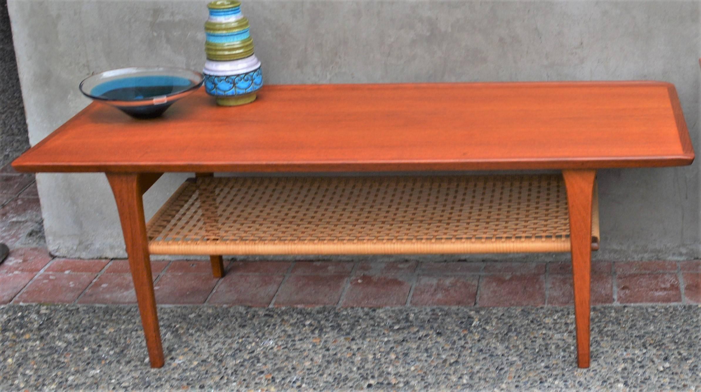 Danish Teak Coffee Table Flared Edges and Lower Cane Shelf by Mobelintarsia In Excellent Condition In New Westminster, British Columbia