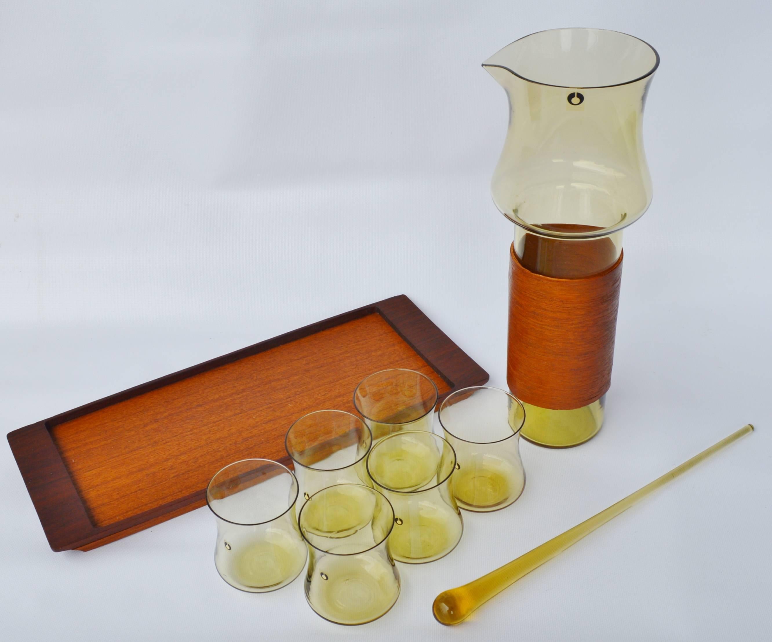Swedish Goran Warff Pukeberg Amber Glass Pitcher & Six Glasses, Stir Stick & Teak Tray For Sale