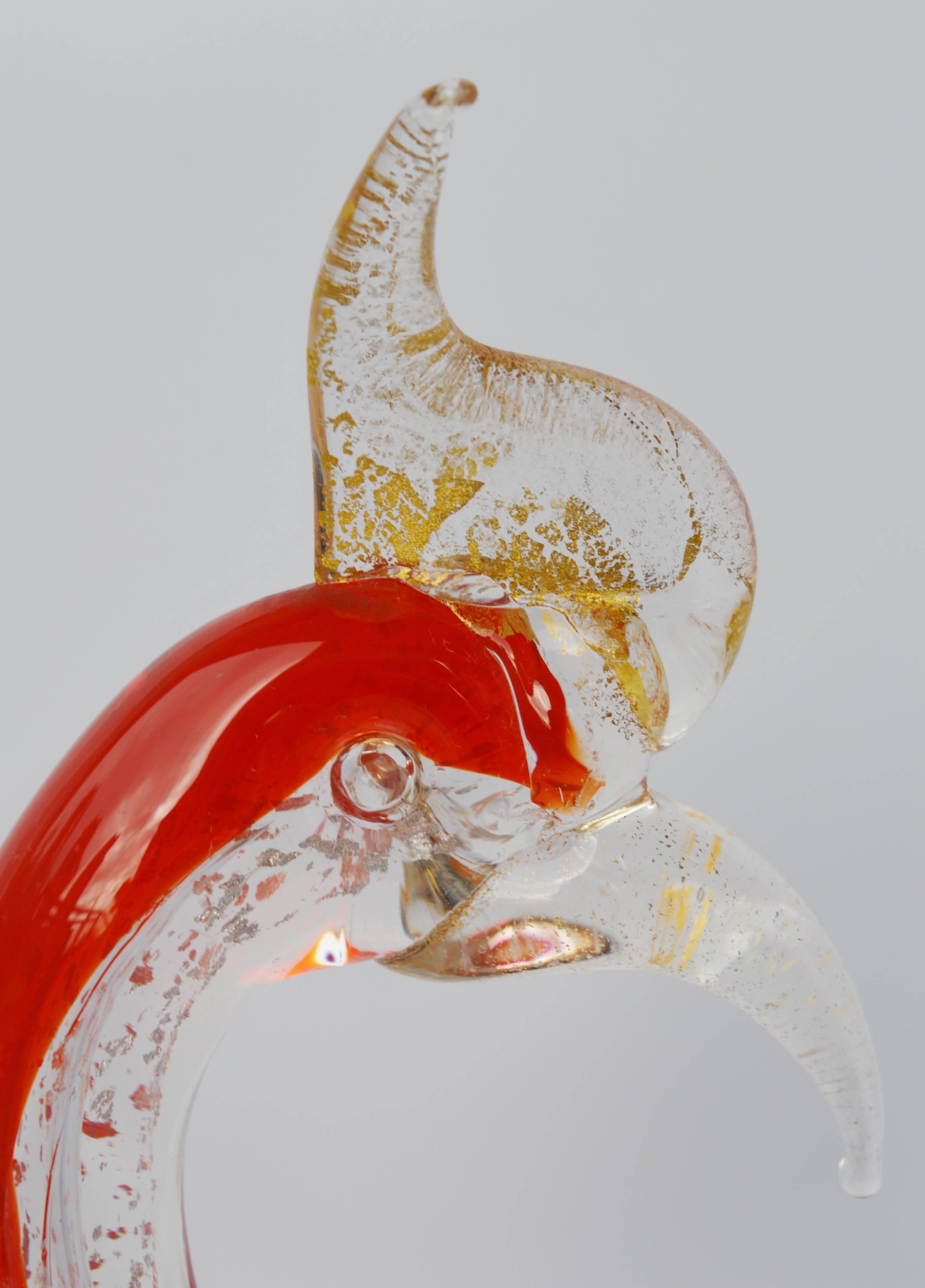 This dramatic and spirited handblown Mid-Century rooster figurine is delightful! The transparent sections of clear glass speckled with gold flecks, combined with the solid red on the back, gives it a Minimalist and airy feel. The character of the