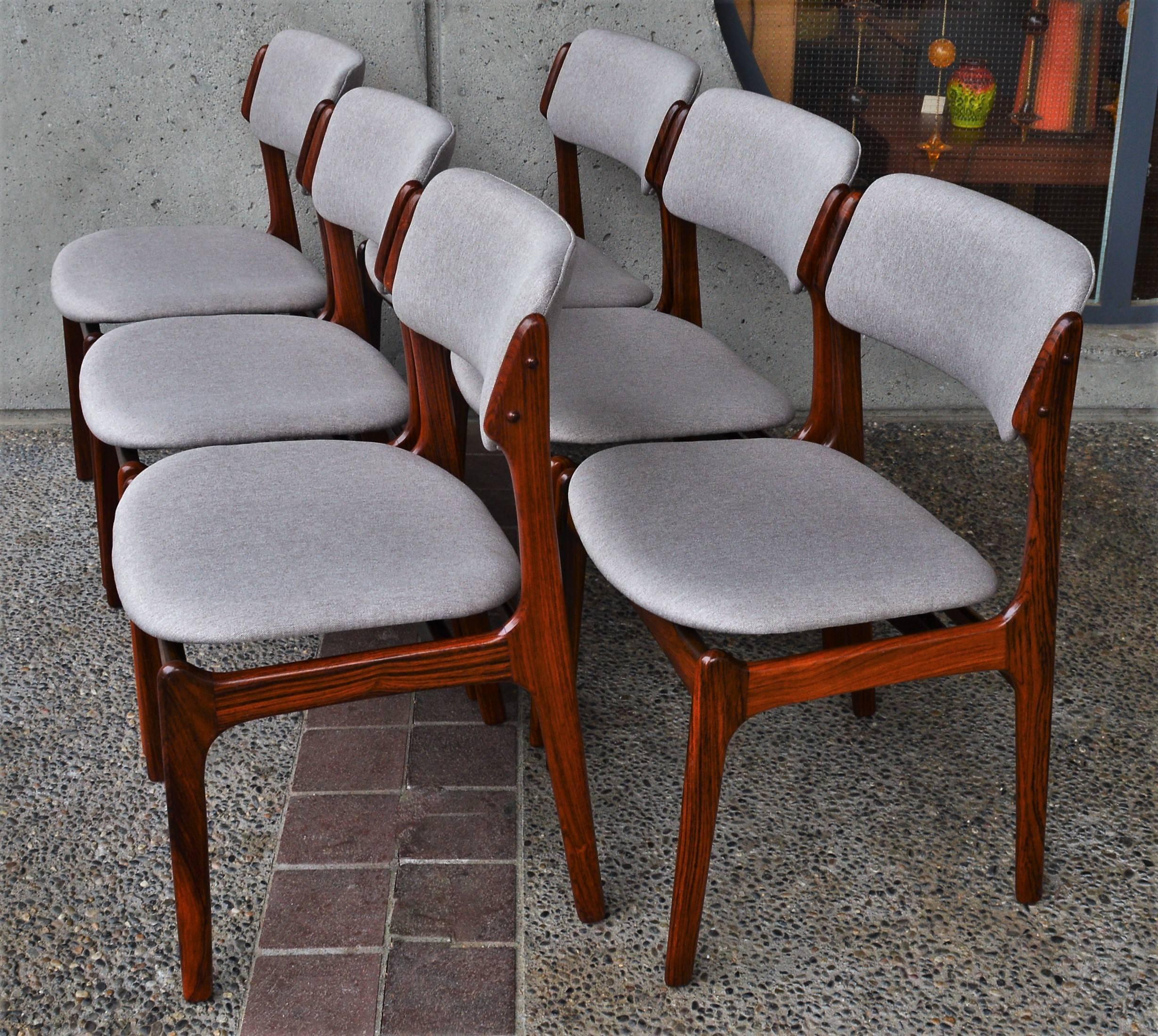 This gorgeous set of early Erik Buch model 49 rosewood dining chairs are renowned for their amazing comfort with the perfect angle of the upholstered backrest and the slight hug of the curved seat. While also being ergonomic, they also have stunning