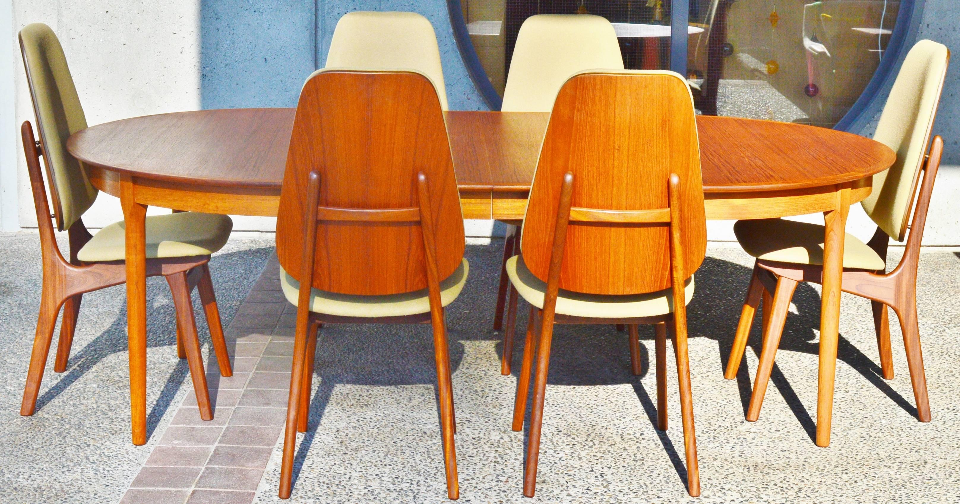 This lovely set of Danish modern teak tall shield-back dining chairs were designed by Arne Hovmand-Olsen and are the rare version with the very tall upholstered back which makes them amazingly comfortable. Note the floating backrest that is spaced
