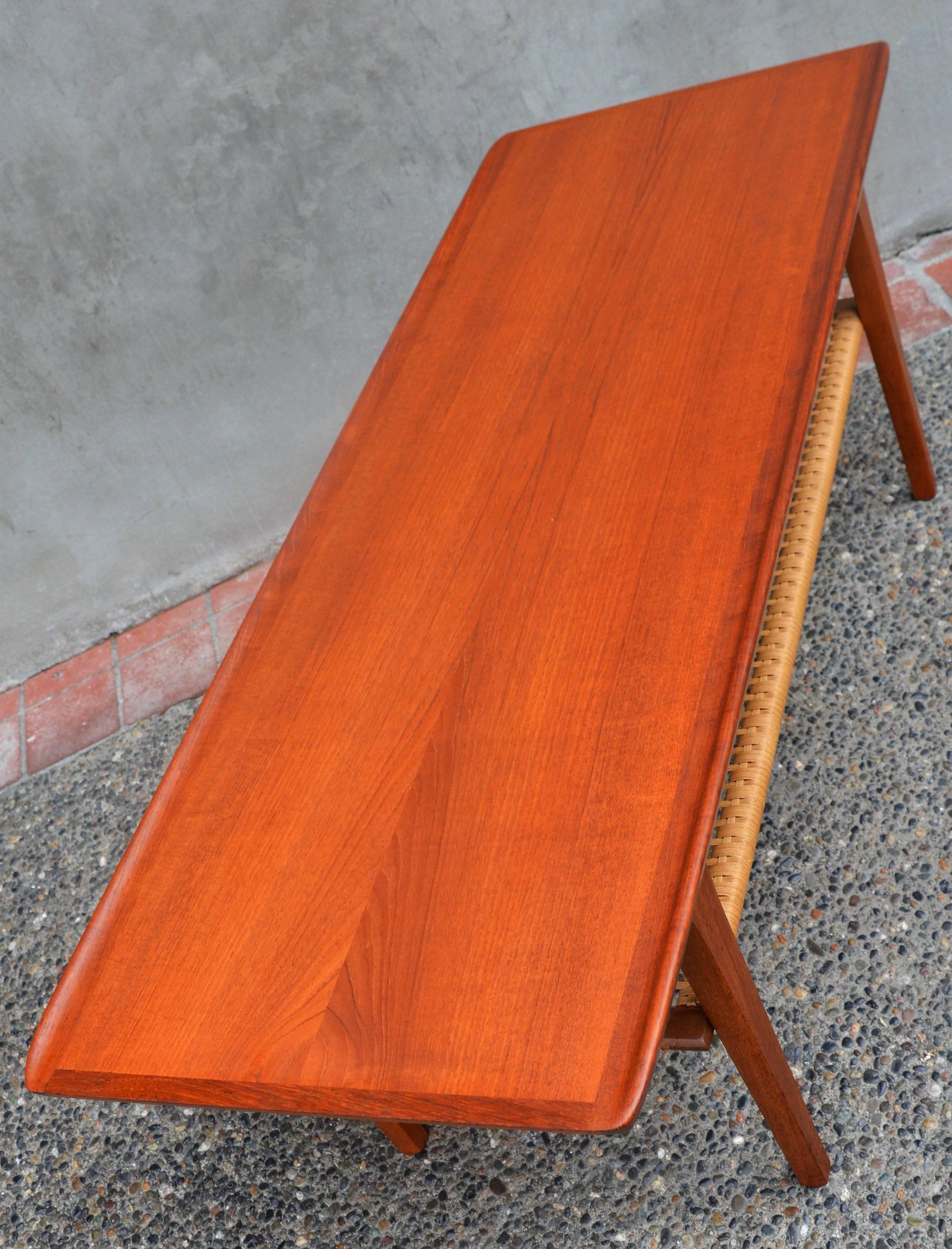 Mid-20th Century Danish Teak Coffee Table Flared Edges and Lower Cane Shelf by Mobelintarsia