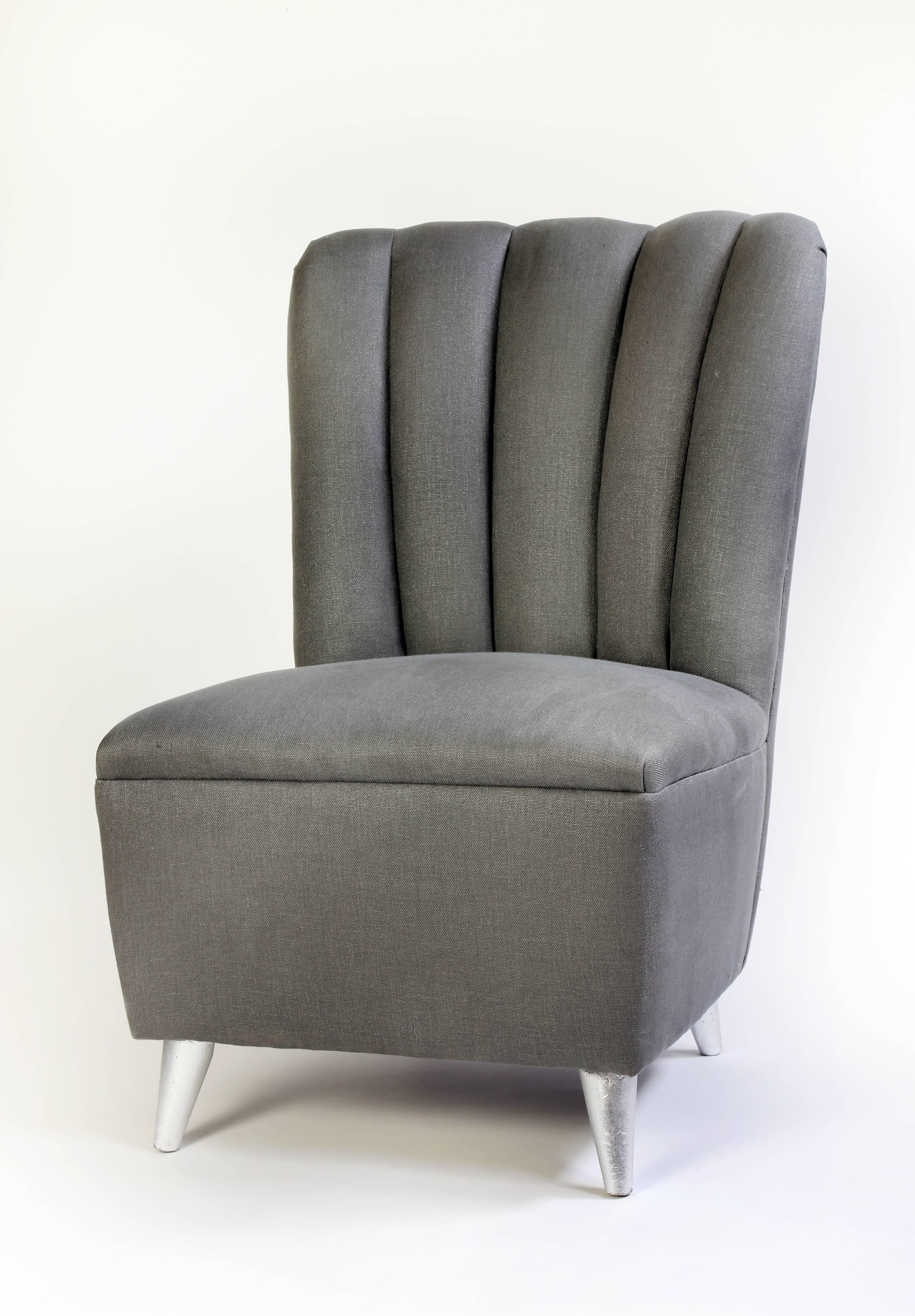 Italian Mid-Century Modern upholstered chairs, circa 1950, newly upholstered in charcoal linen, rising on four feet with silver leaf. Discoloration to fabric.