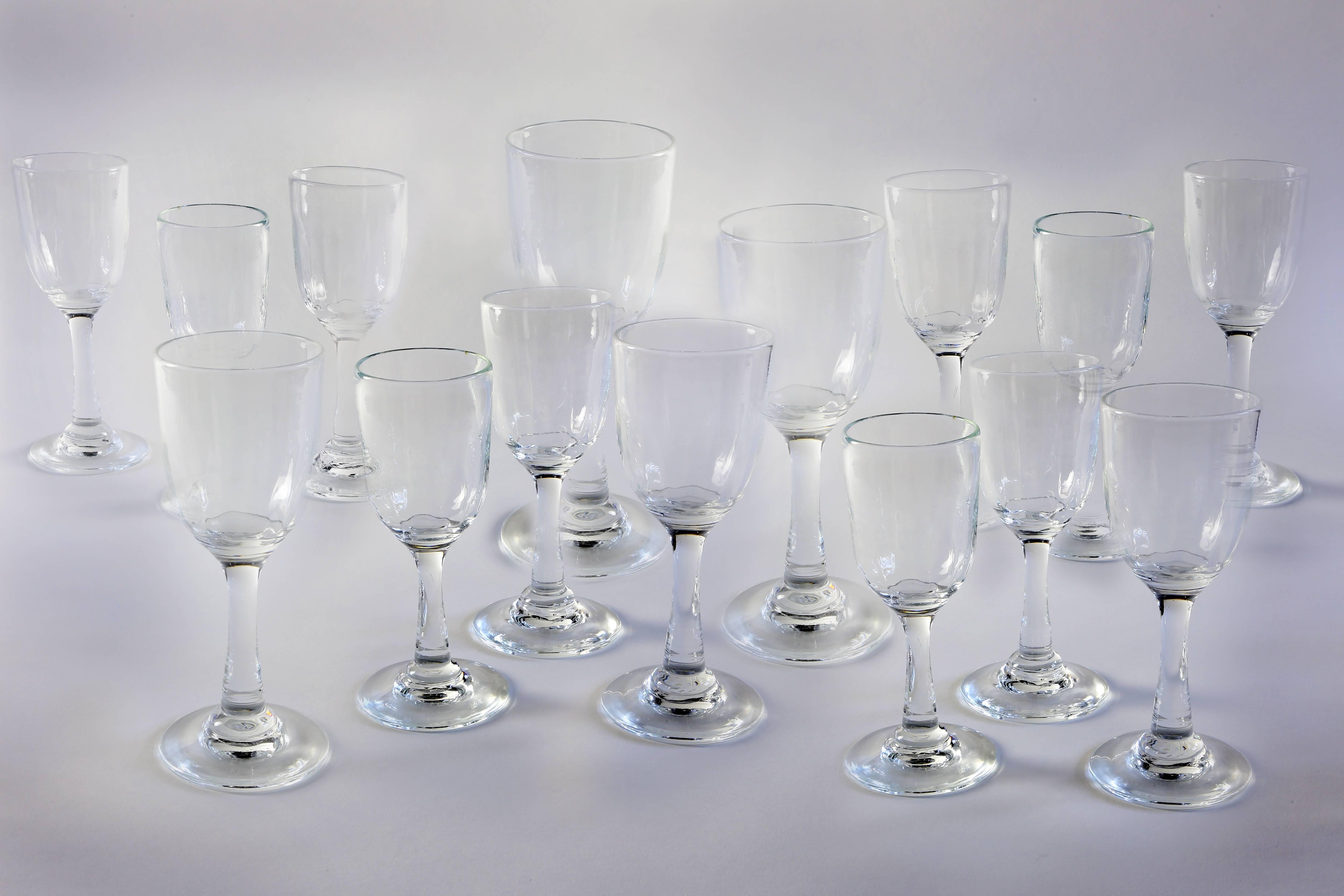 A set of 15 blown glasses that are of varying heights and sizes from Pierre Deux in France, late 20th century. Most between 7.5 and 8