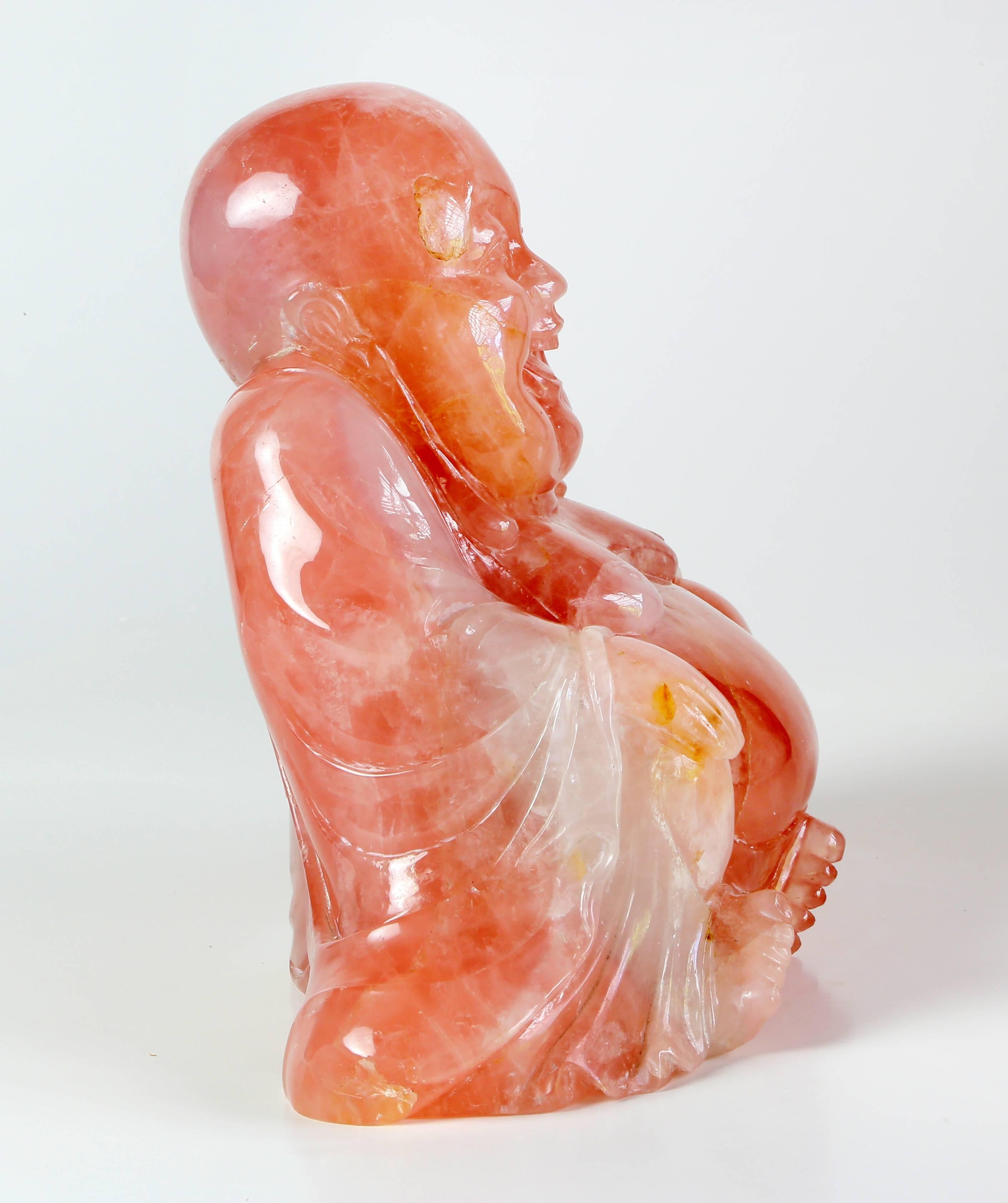 A carved seated Buddha carved from Asian rose quartz.