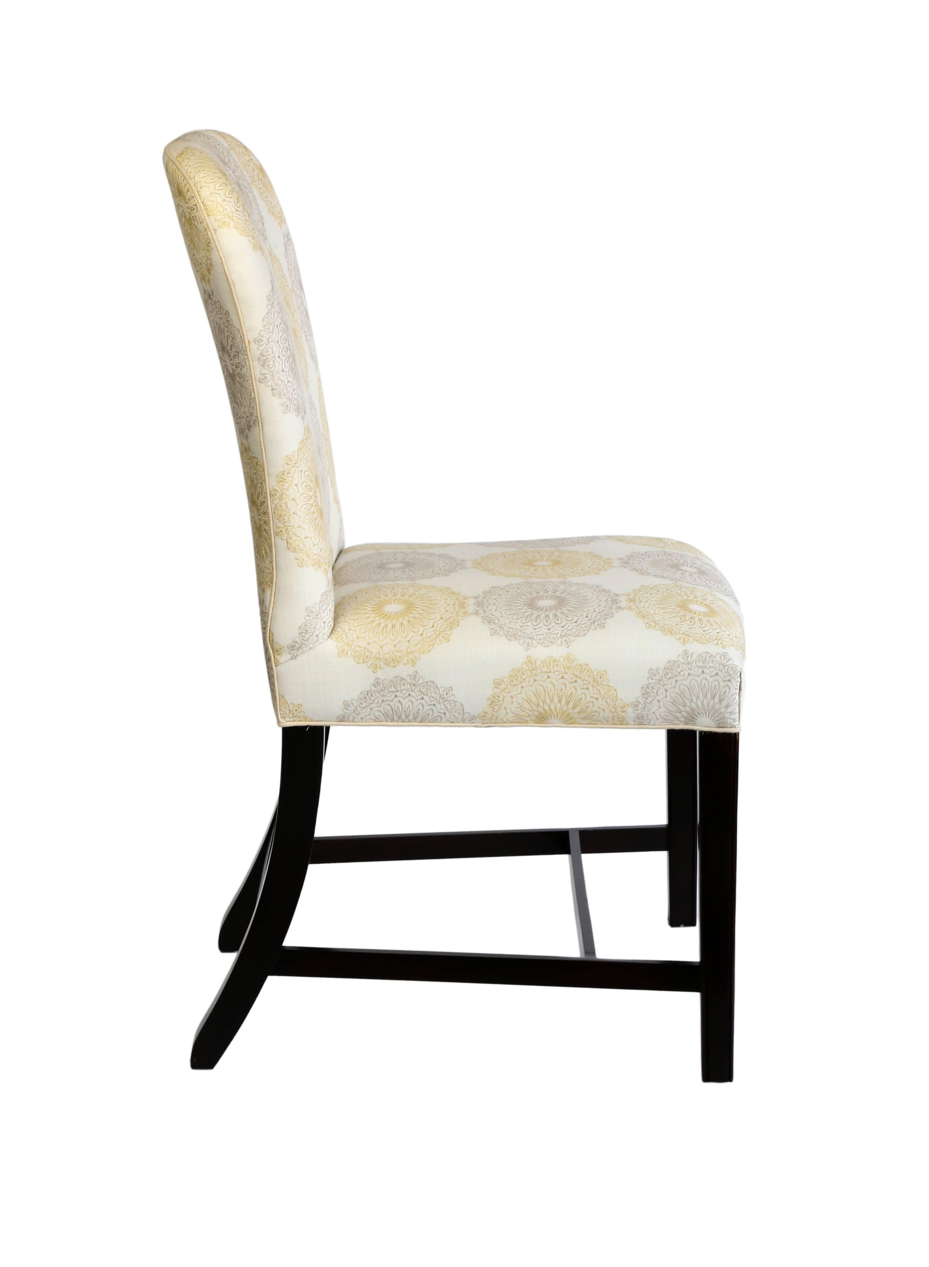 Ten upholstered side chairs with a dark mahogany finish on the legs and stretcher.