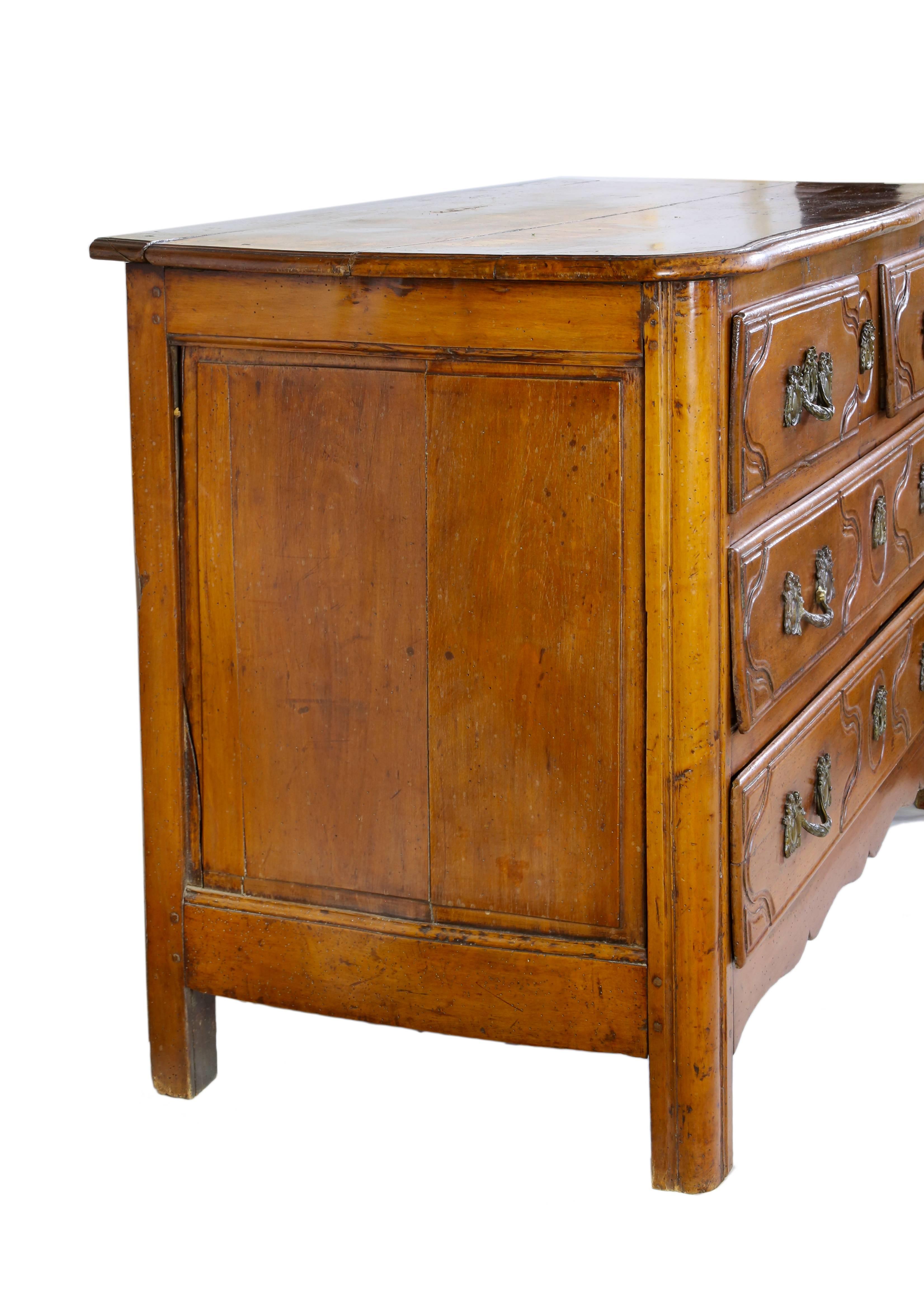 French Louis XV walnut commode, 18th century, having two short drawers over two long drawers, rising on straight supports.